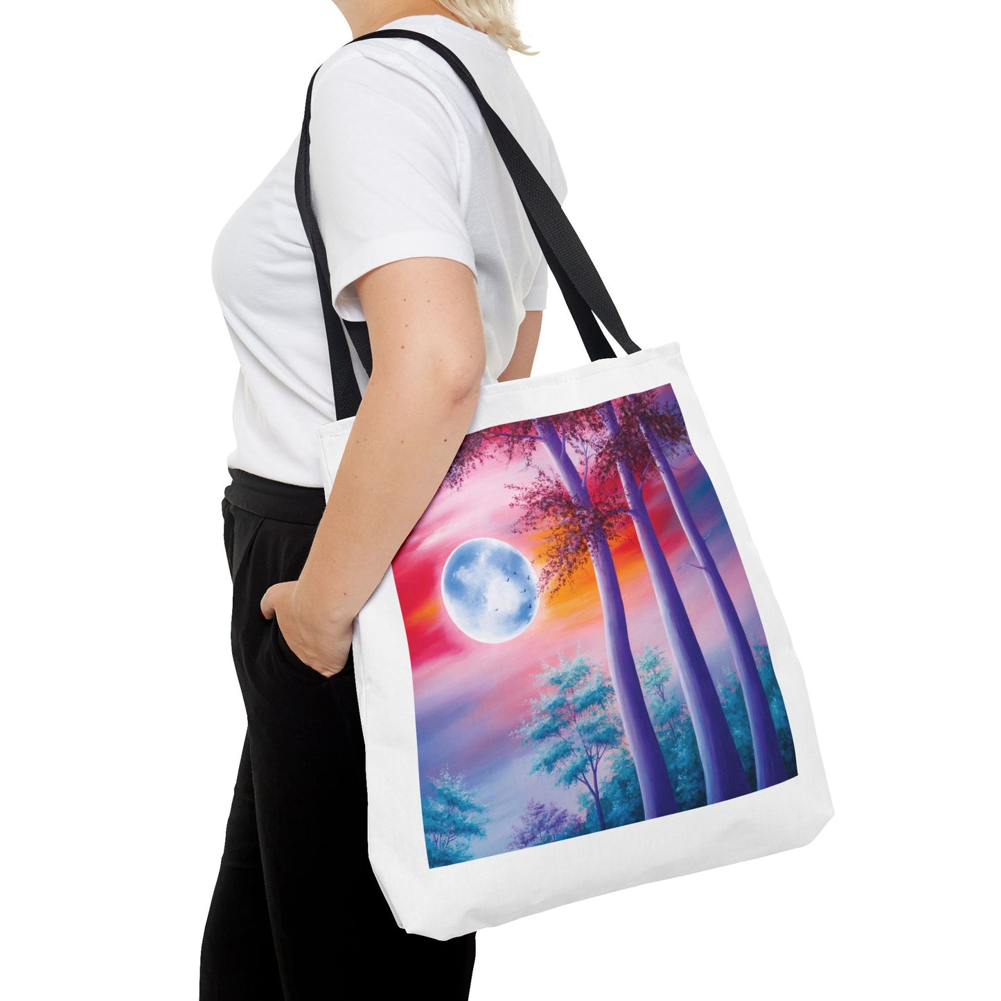 Moonlit Forest Tote Bag featuring a mystical full moon scene with towering trees against a dramatic sunset sky. Durable polyester with reinforced handles, ideal for art lovers and everyday use. Available in three sizes.