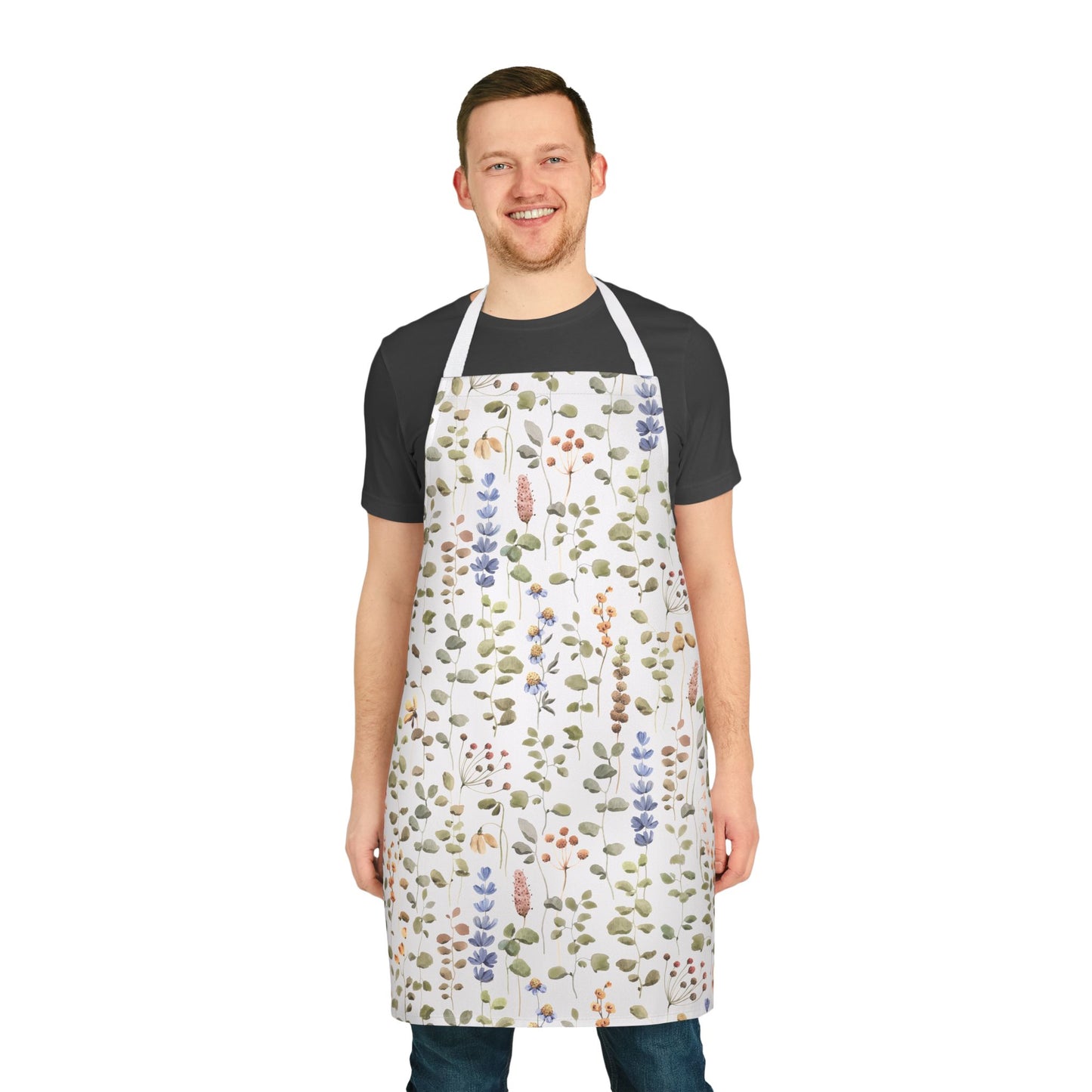 A man wearing an apron with a vibrant wildflower design, showcasing the Apron, Wildflower Design, 5-Color Straps from FireBrook Essentials, ideal for enhancing cooking or crafting activities with style and comfort.