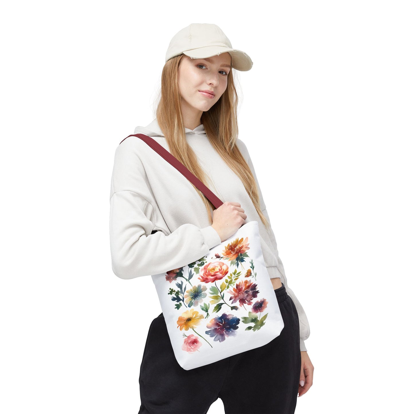 Woman in hat holding Watercolor Floral Tote Bag, showcasing its stylish, durable design ideal for daily use. Perfect for adding charm to errands or adventures.