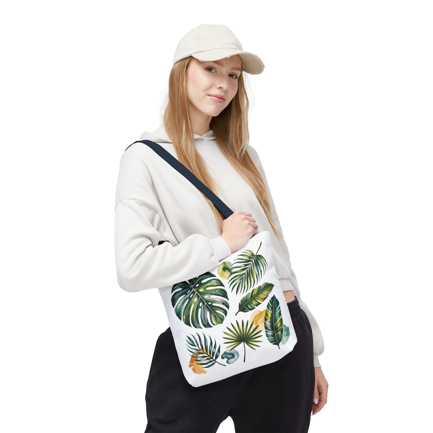 Tropical Leaves Tote Bag, featuring a vibrant leaf pattern, showcases durability and spacious design, perfect for summer outings. Reinforced handles and boxed corners ensure style and practicality for eco-conscious beach lovers.