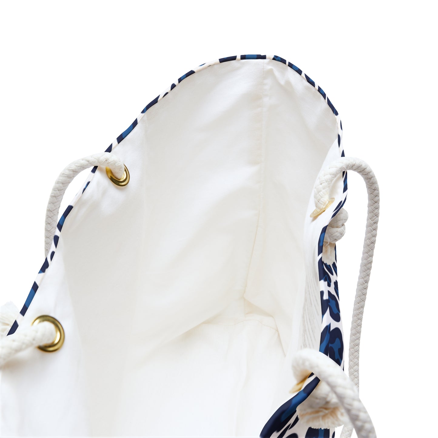 Weekender Bag Blue Cheetah Print featuring a close-up of the sturdy white rope handles with gold rings and a dynamic blue and white animal pattern, embodying a stylish, adventurous travel accessory.