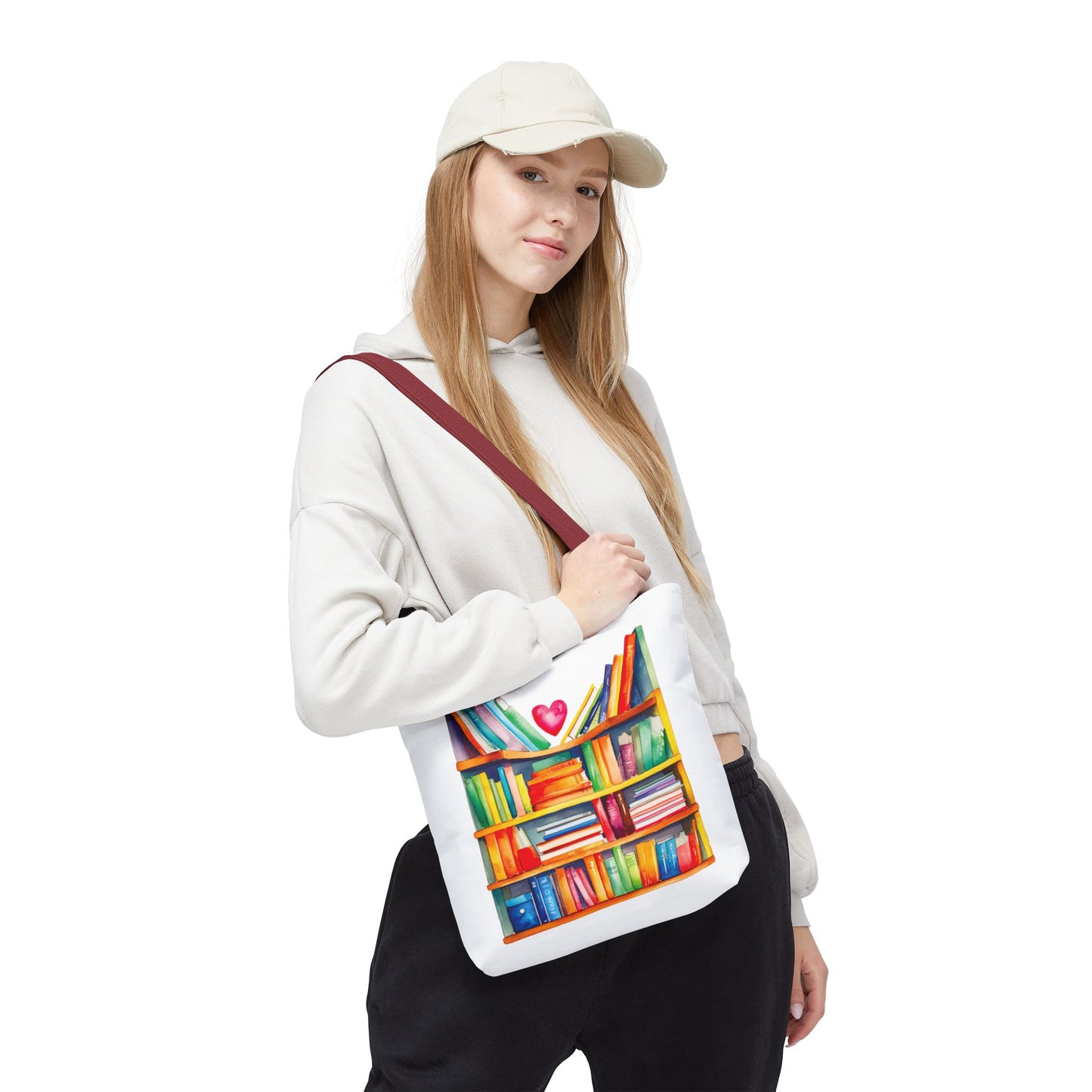 Woman wearing a white cap holds a Books Tote Bag - 100% Spun Polyester, featuring a bookcase design, ideal for book lovers seeking durability and style.
