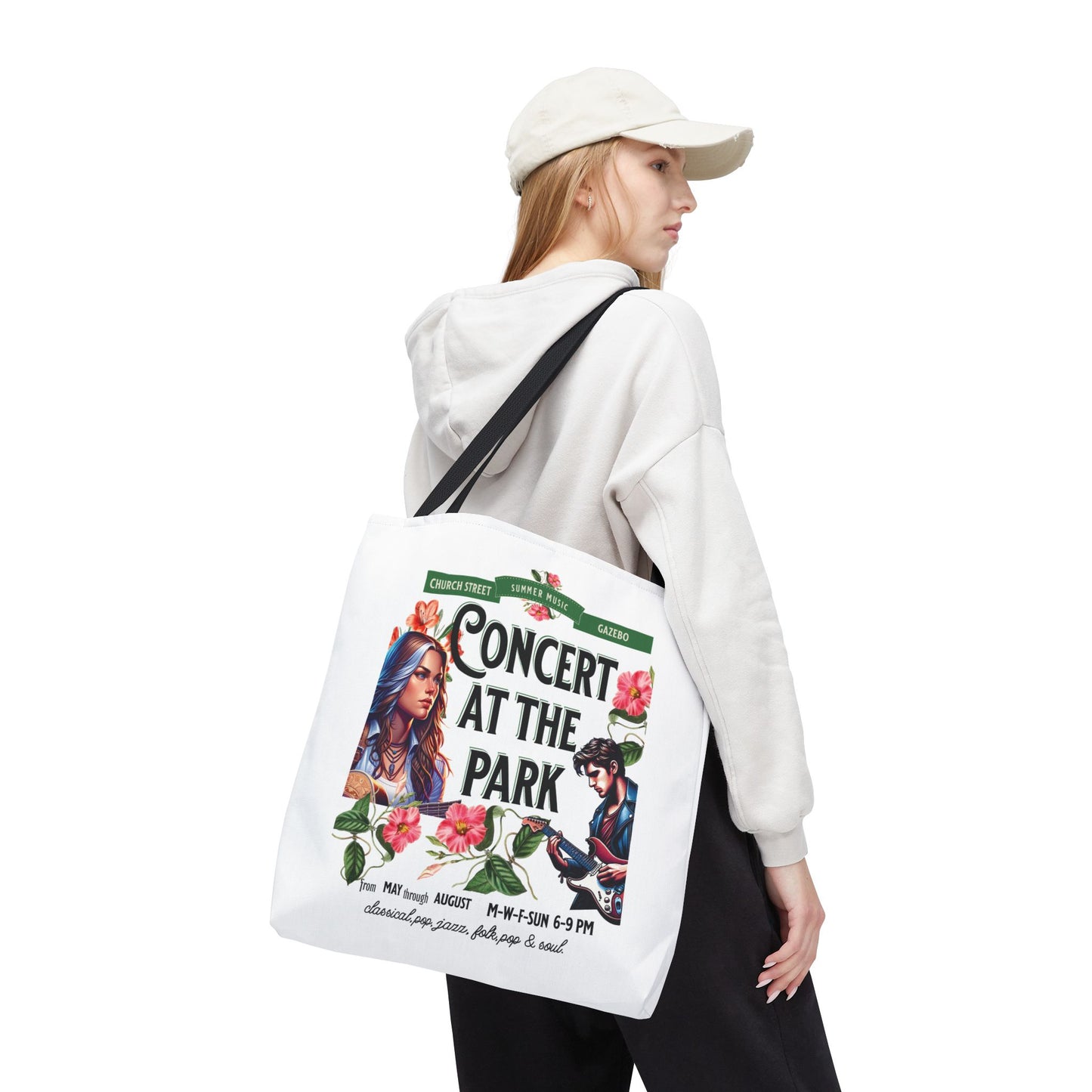 Concert At the Park Tote Bag featuring a lively concert design, held by a woman in a white hat and sweatshirt, ideal for summer outings.