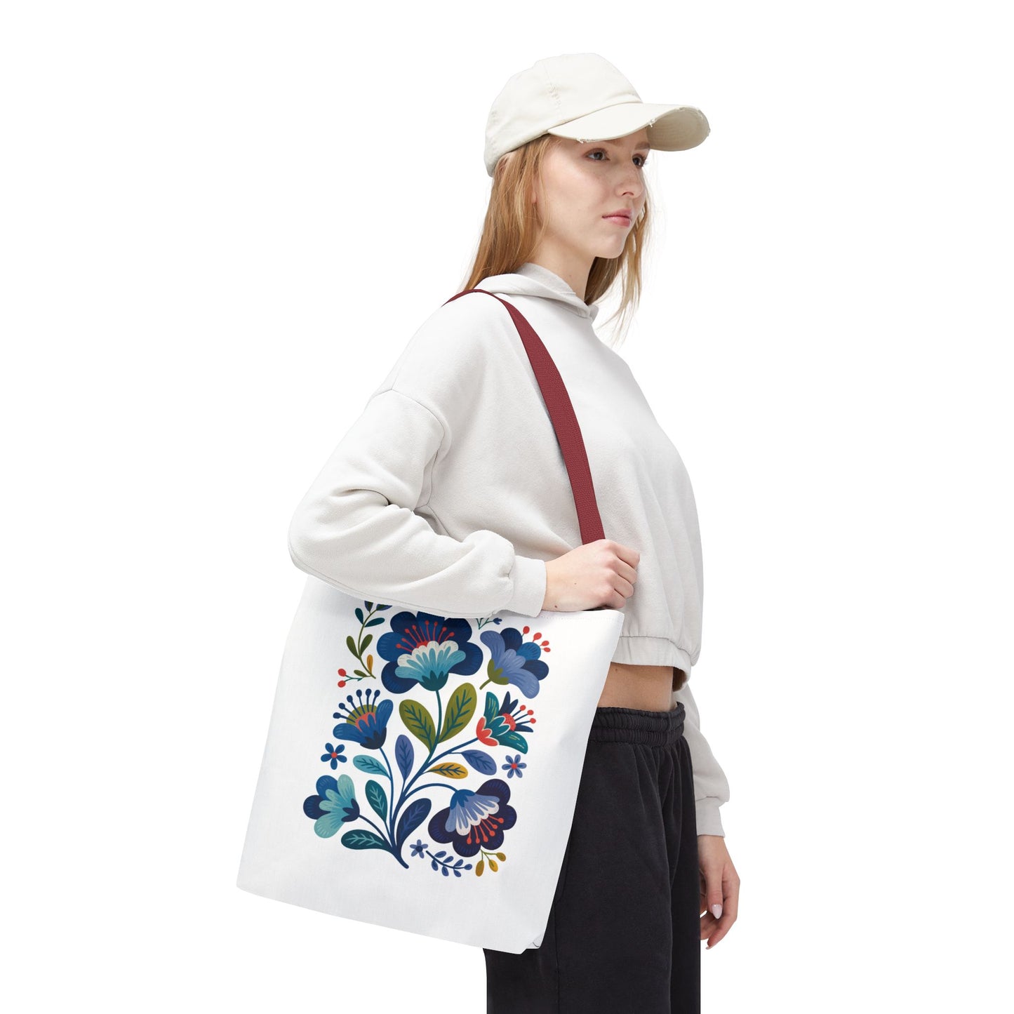 Vintage Folk Art Design Blue Floral Tote Bag featuring a charming blue floral folk art pattern, perfect for adding a touch of nostalgia and style to everyday outfits or special occasions.