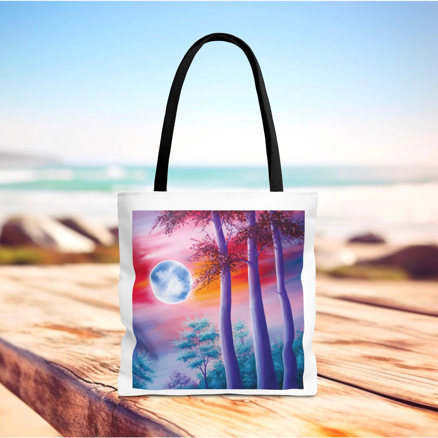 Moonlit Forest Tote Bag featuring a mystical full moon scene with towering trees against a dramatic sunset sky. Durable polyester design with reinforced handles, perfect for art lovers and everyday use.