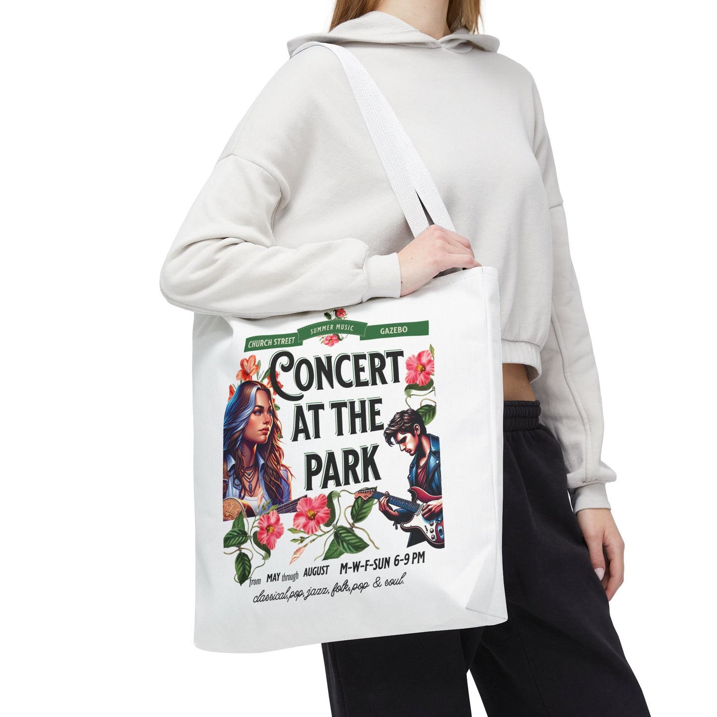 Concert At the Park Tote Bag held by a woman, featuring a vibrant design of a man and woman, perfect for music lovers and outdoor activities.
