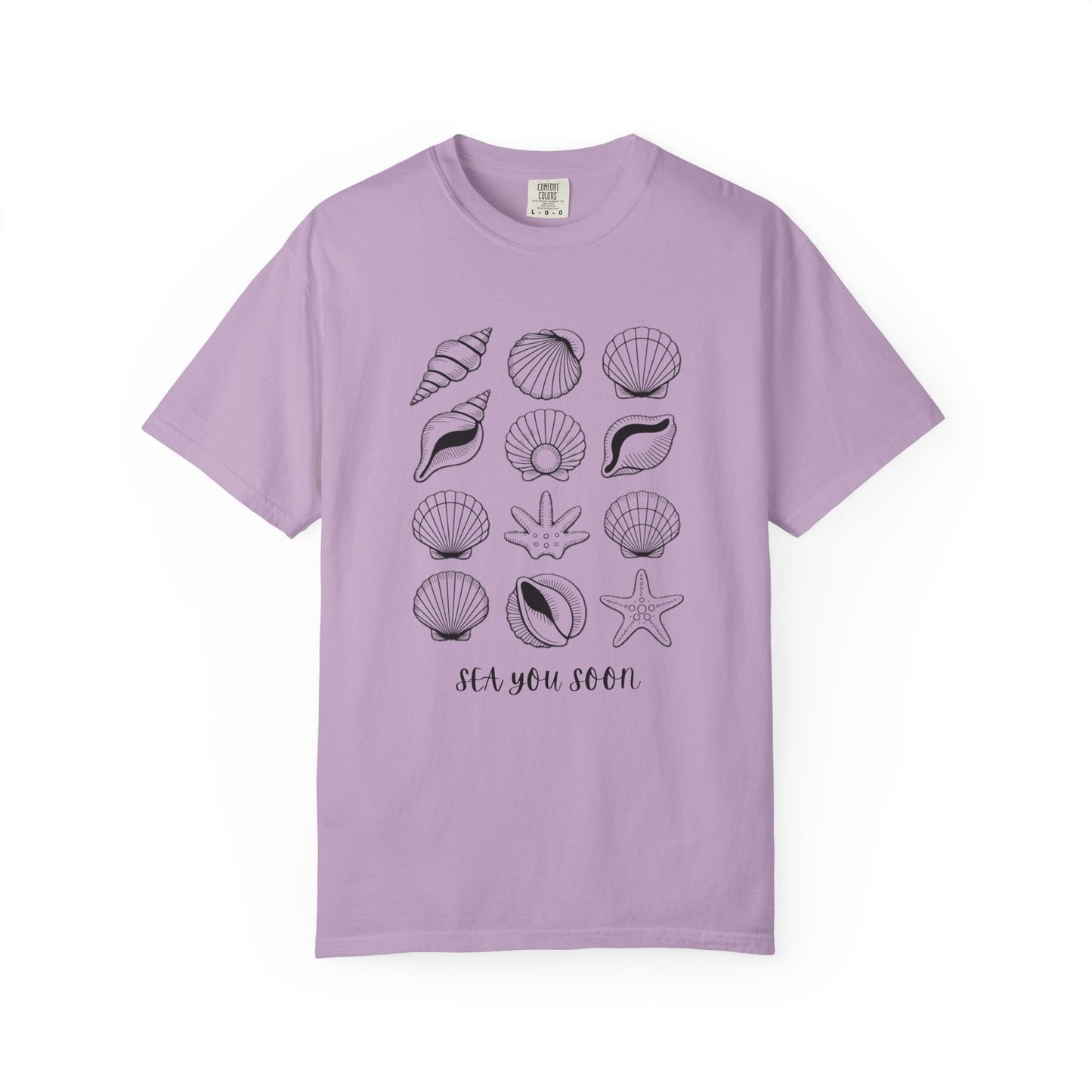 Seashells and Sea You Soon T-Shirt showcasing a relaxed fit with a beachy theme. Features seashell designs and text, ideal for ocean lovers. Made from high-quality, ethically sourced US cotton.
