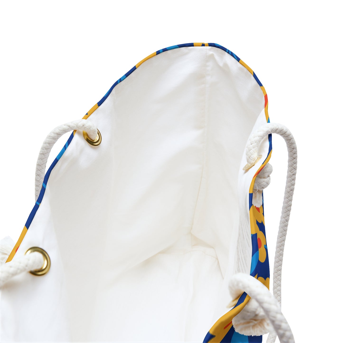 Weekender Bag interior with cream sheeting lining and colorful blue-and-yellow trim, featuring sturdy rope handles through brass grommets; designed for stylish and practical travel adventures.