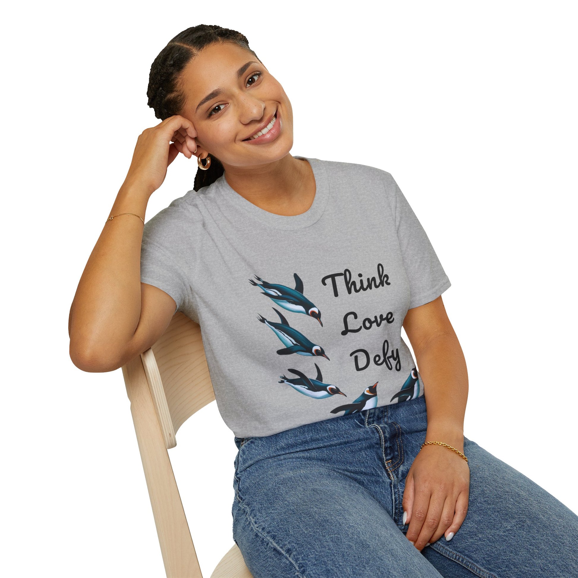 Think Love Defy Penguin Animal Nature Gildan Unisex T-Shirt, featuring penguin designs, worn by a smiling woman sitting casually, embodying comfort and style from FireBrook Essentials.