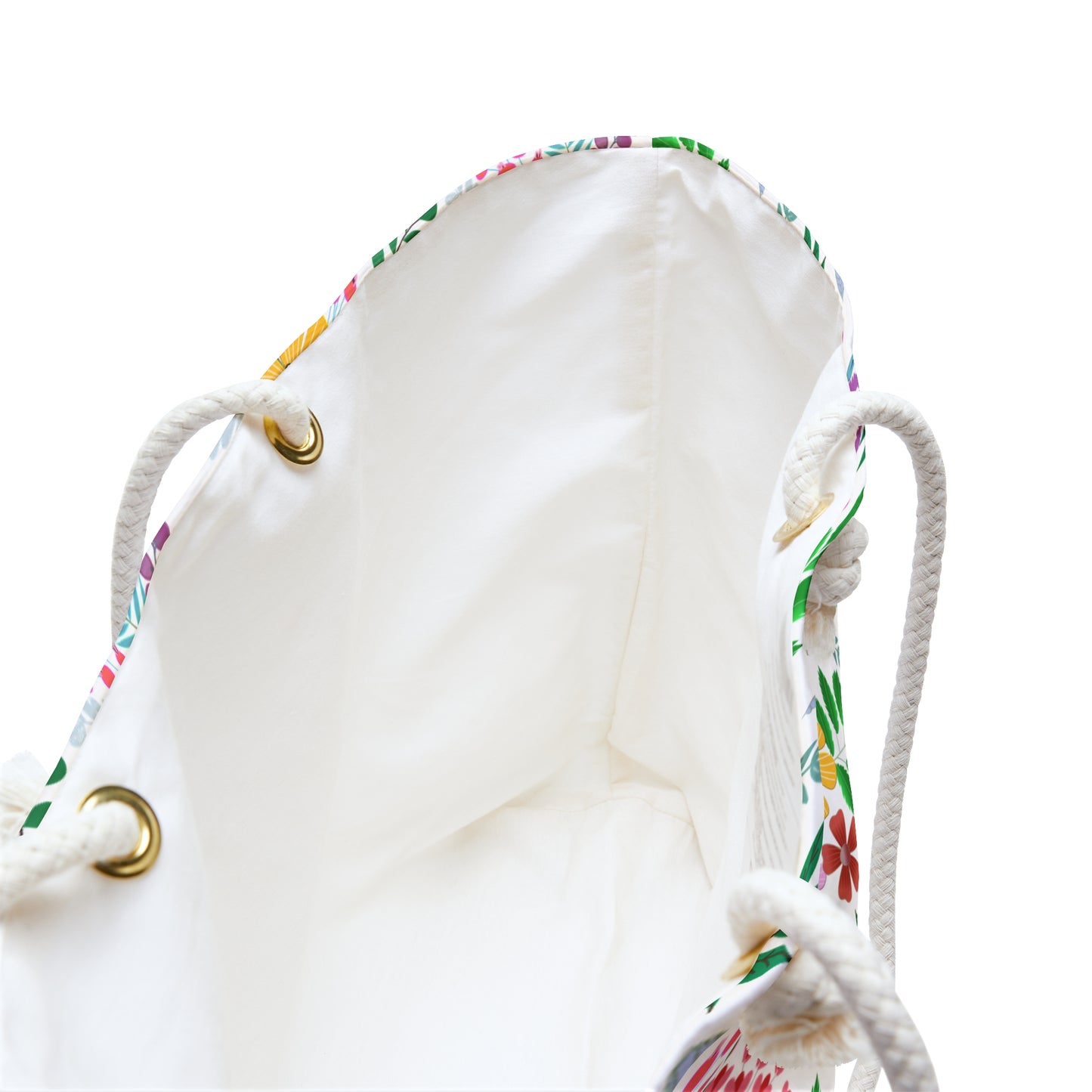 Weekender Bag featuring an off-white canvas with colorful floral trim, thick rope handles through brass grommets, and spacious interior—ideal for stylish travel, embodying FireBrook Essentials' blend of comfort and joy.