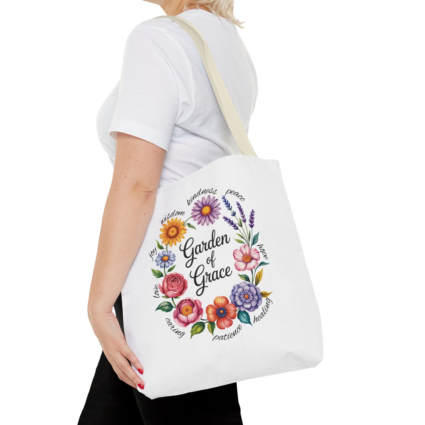 Garden of Grace Watercolor Design Tote Bag showcases hand-drawn flowers in soft pastels with 'Garden of Grace' text, embodying elegance and charm. Perfect for daily use and gift-giving.