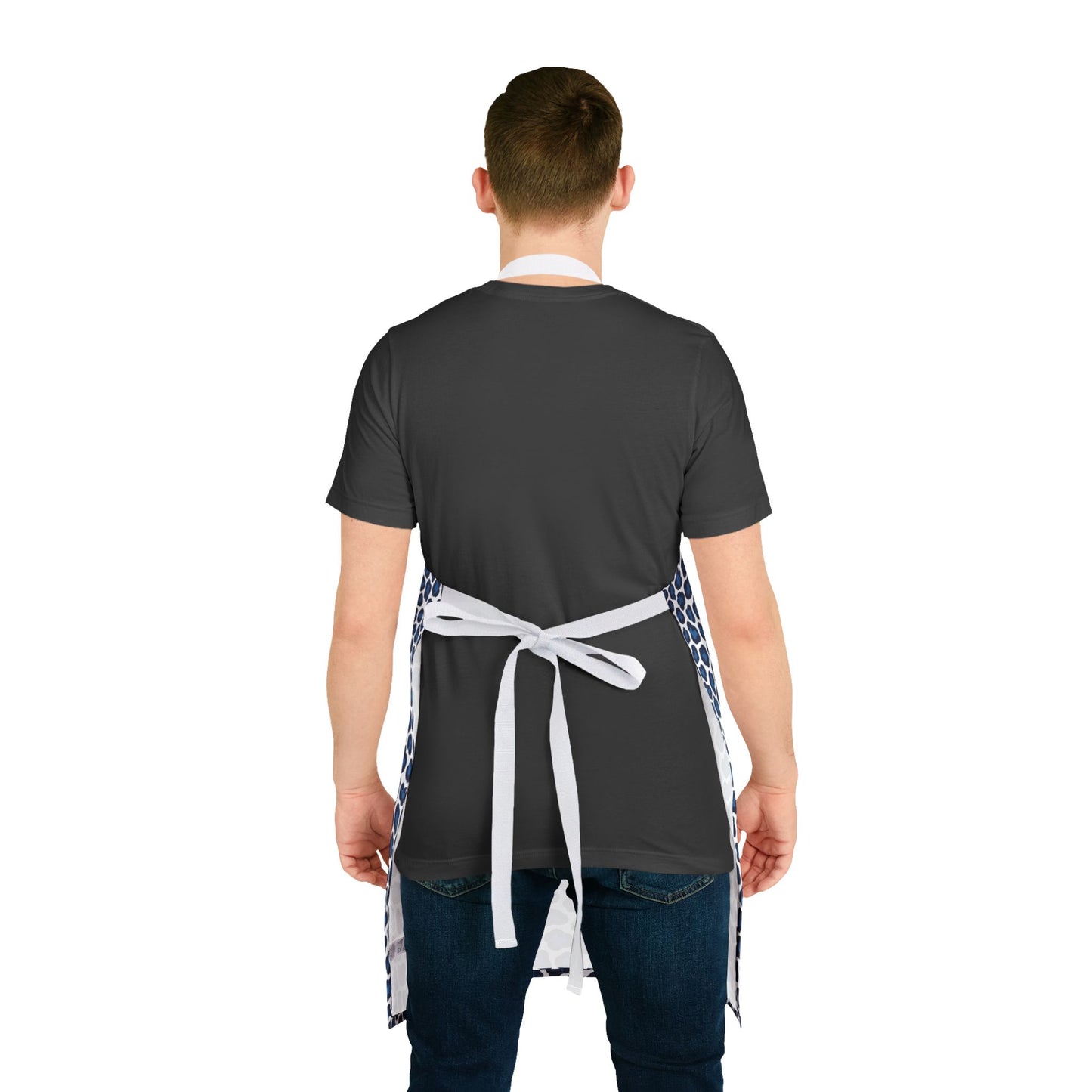 A man in an apron with a blue cheetah print design, showcasing FireBrook Designs' stylish and comfortable apparel, perfect for adding fun and protection during cooking or crafting.