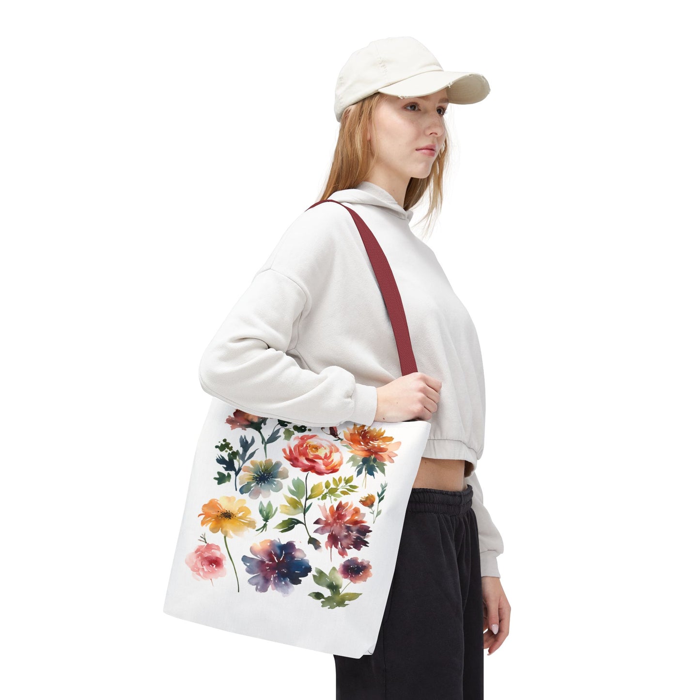 Woman in a white hat holds a Watercolor Floral Tote Bag, ideal for daily use with its durable, stylish design.