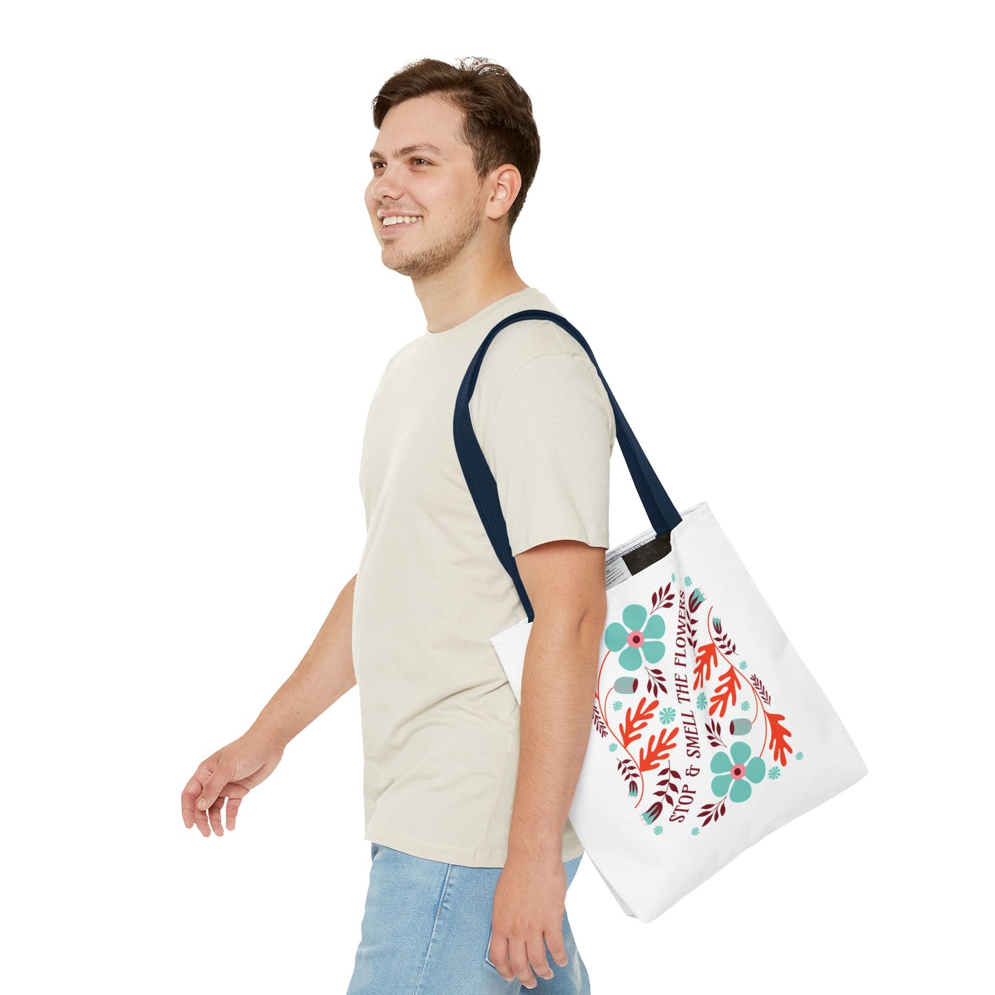 Man smiling while carrying the Stop and Smell The Flowers Tote Bag, showcasing its floral design and sturdy handles, ideal for everyday use.