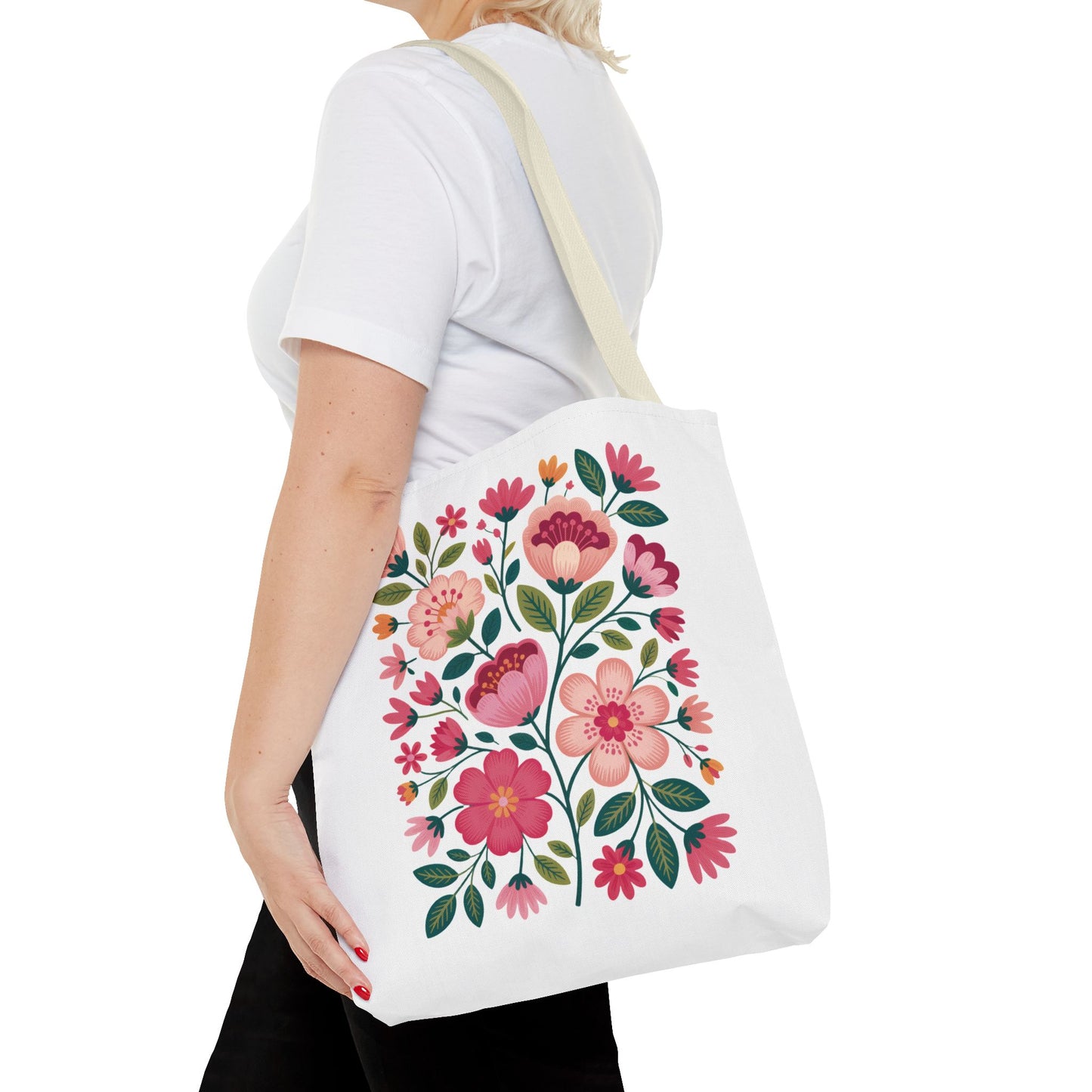 Pink Floral Folk-Art Style Tote Bag with vibrant, organic floral illustrations in pink tones, complemented by dusty green leaves. Ideal for carrying essentials, offering both style and durability with reinforced handles.