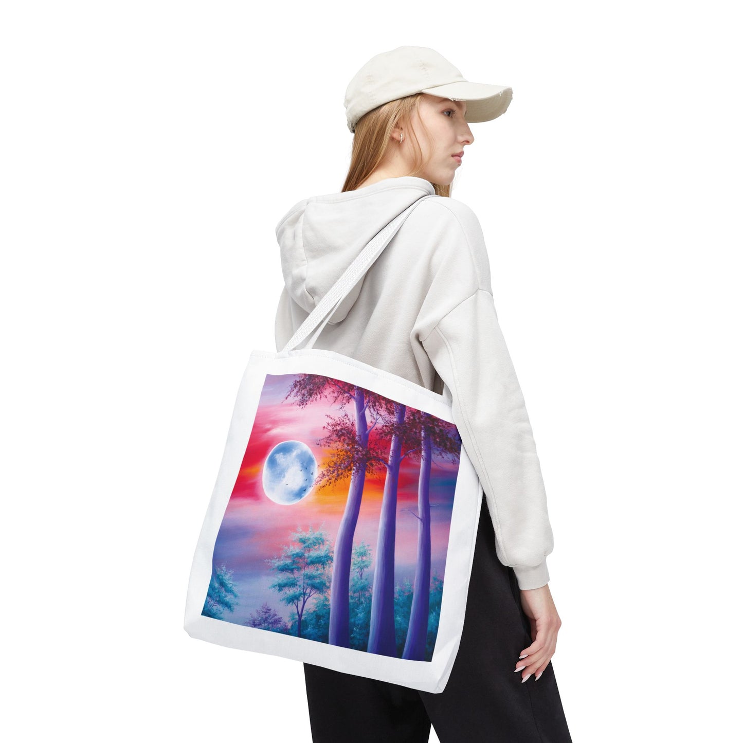 Moonlit Forest Tote Bag features a mystical full moon scene with towering trees against a dramatic sunset sky, perfect for art lovers. Durable 100% polyester, available in three sizes with customizable handles.