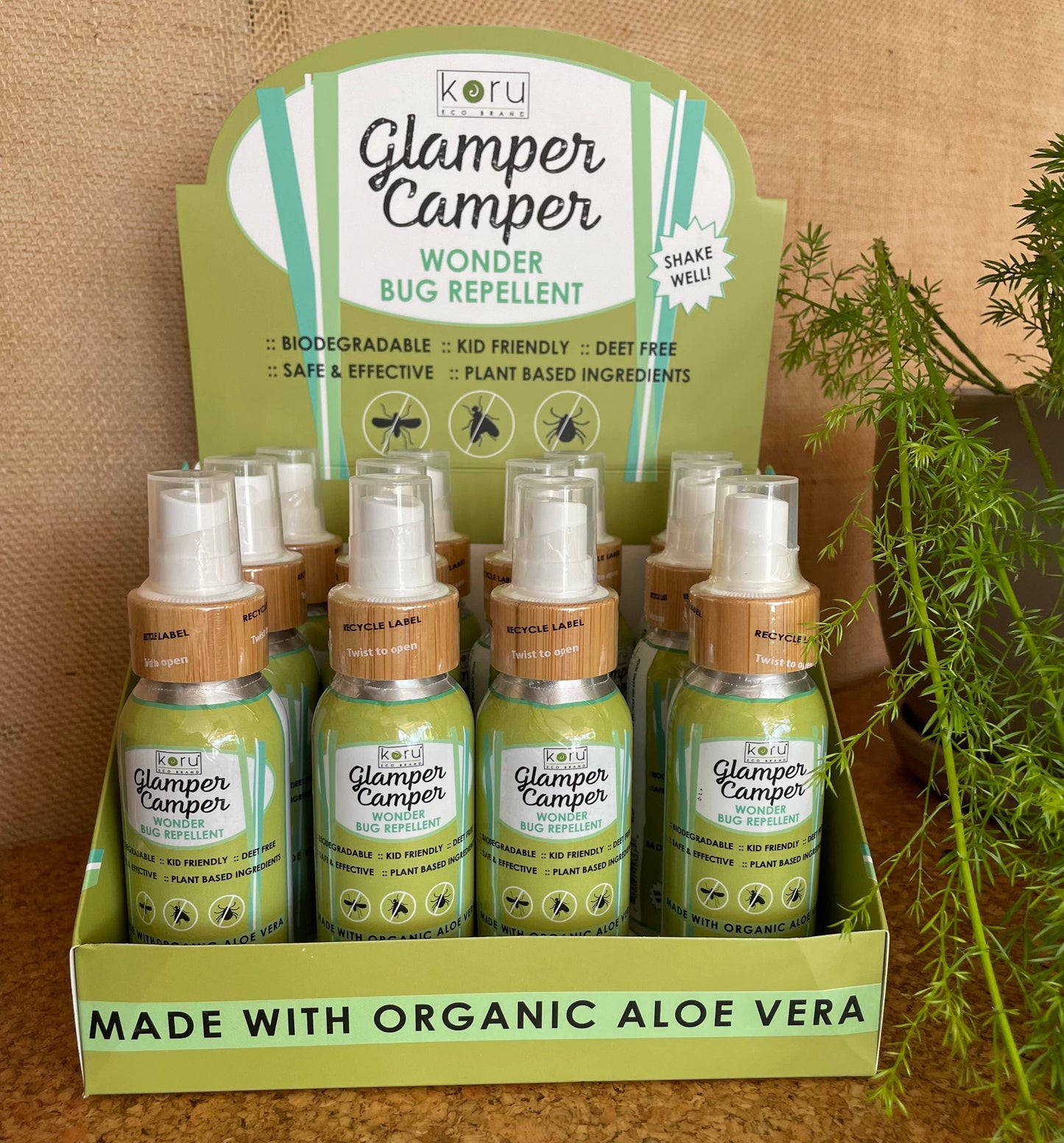 Glamper Camper Wonder Bug Repellent bottles, elegantly displayed in a custom tray, highlight their biodegradable, kid-friendly, DEET-free formula, featuring plant-based ingredients like organic aloe vera, ideal for outdoor adventures.
