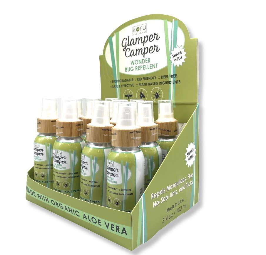 Glamper Camper Wonder Bug Repellent display with several travel-size spray bottles in a green and white packaging, featuring organic aloe vera, biodegradable, DEET-free, plant-based ingredients; perfect for outdoor adventures.