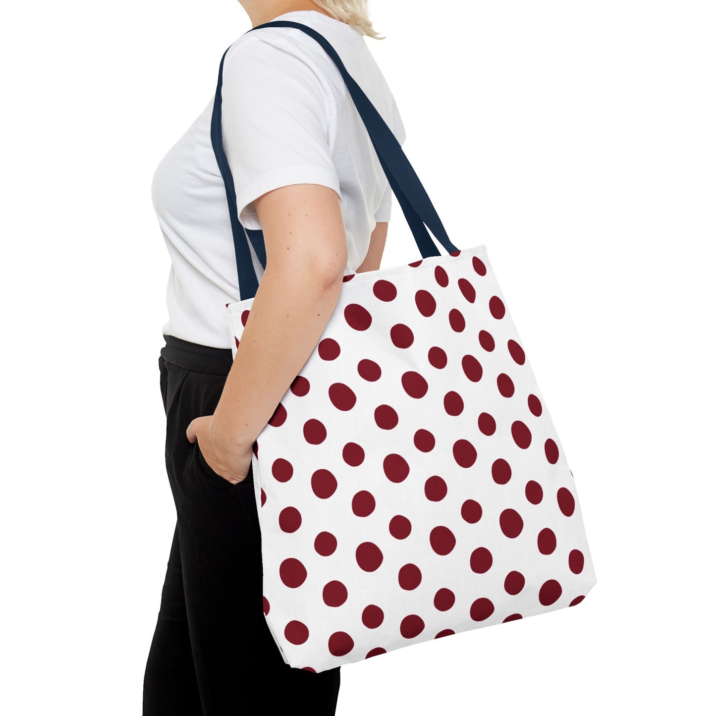 Burgundy Polka Dots Tote Bag: A woman displays a stylish and functional tote, showcasing its durable polyester fabric and reinforced handles, perfect for everyday use.