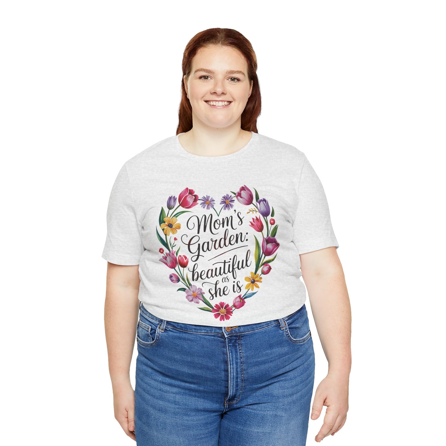 Mom's Garden is as Beautiful as She Is Mother's Day Comfort Colors Unisex T-Shirt features a heart-shaped floral design. The woman smiles warmly, embodying the shirt's uplifting and nature-inspired theme.