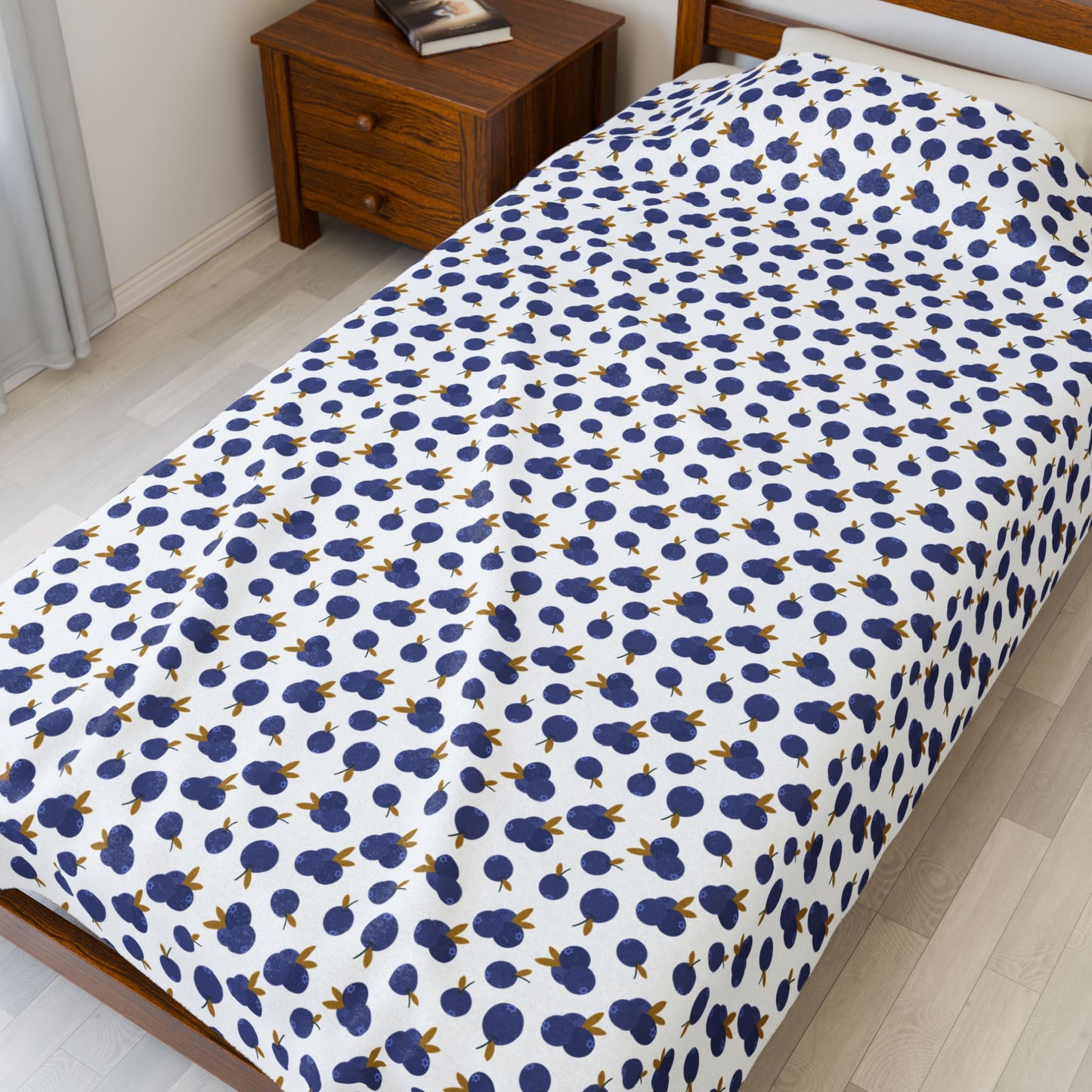 Plush Blanket - Blueberry Pattern draped over a bed, showcasing its cozy texture and intricate design, perfect for adding warmth and style to your home, aligning with FireBrook Essentials' joyful living ethos.