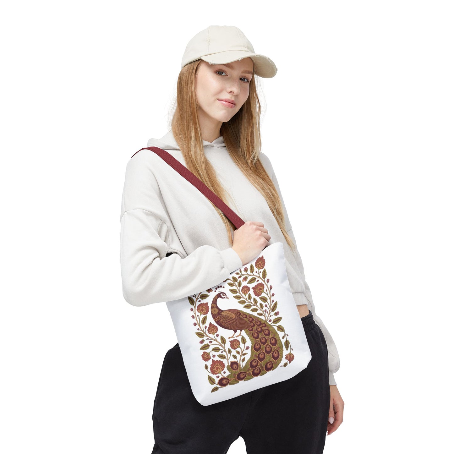 Peacock Tote Bag with Floral Vines and Paisley Motifs, showcasing a detailed peacock surrounded by floral vines and paisley, held by a hand, reflecting FireBrook Essentials' blend of style and nature appreciation.