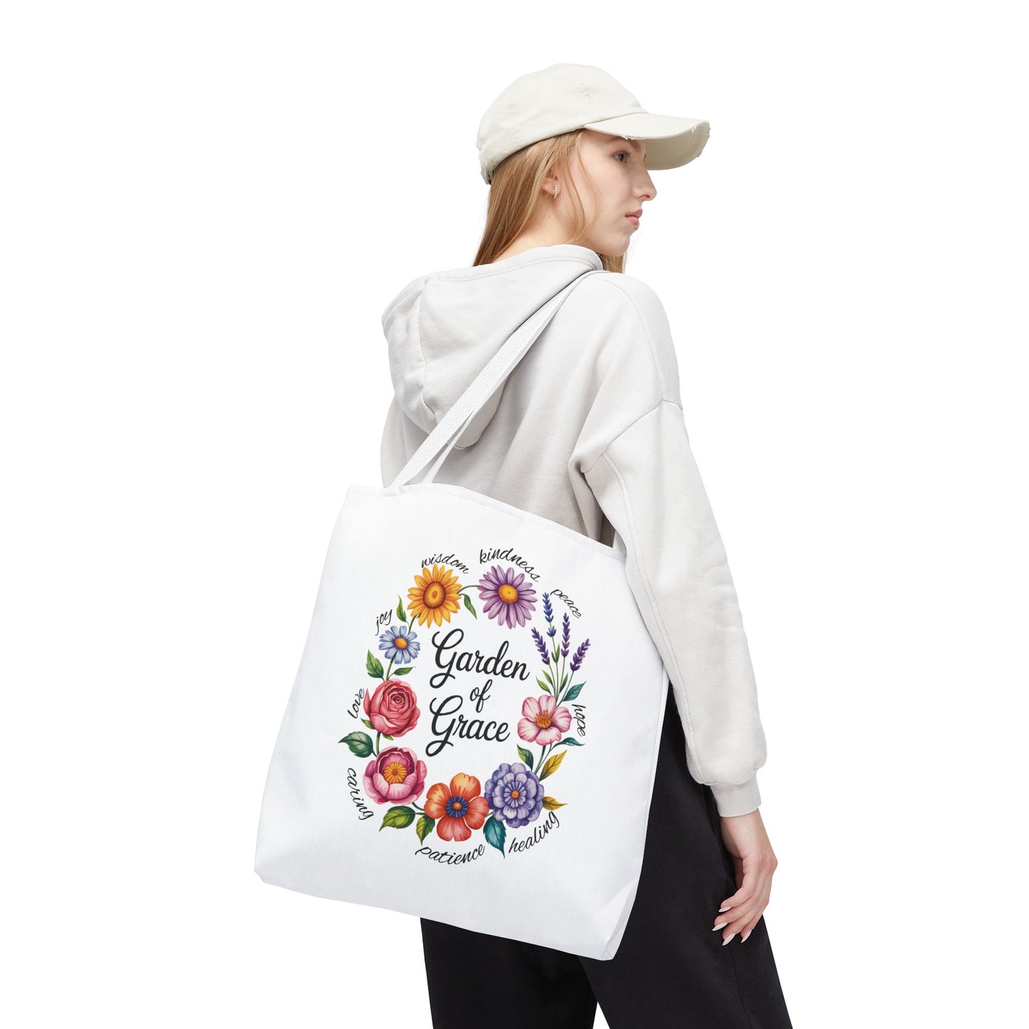 Garden of Grace Watercolor Design Tote Bag features hand-drawn flowers in pastel hues with 'Garden of Grace' text, ideal for nature lovers seeking charm and durability for everyday use.