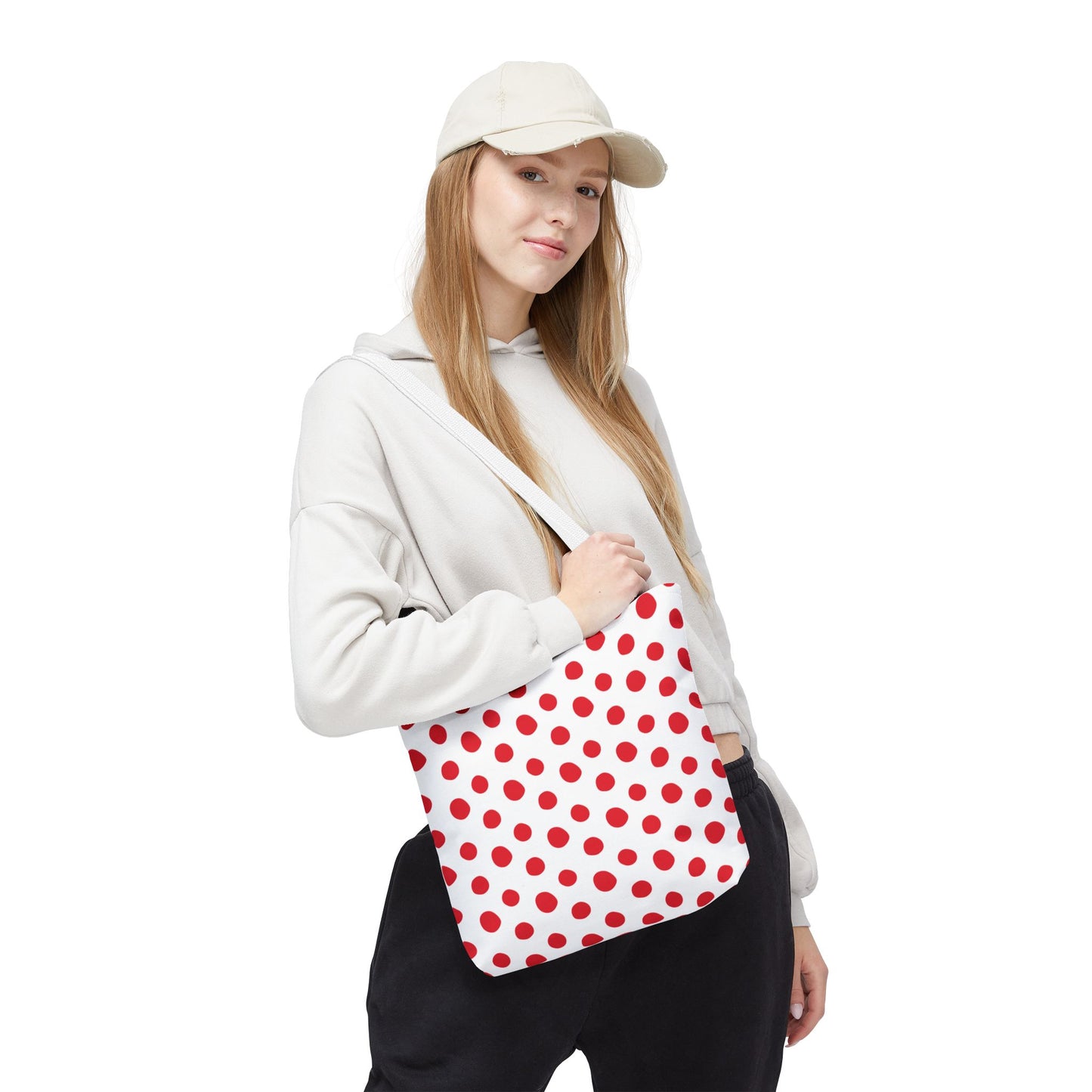 Woman holding Red Polka Dots Tote Bag, showcasing its playful design ideal for daily use. The bag complements casual outfits, aligning with FireBrook Essentials' focus on stylish, joyful living.
