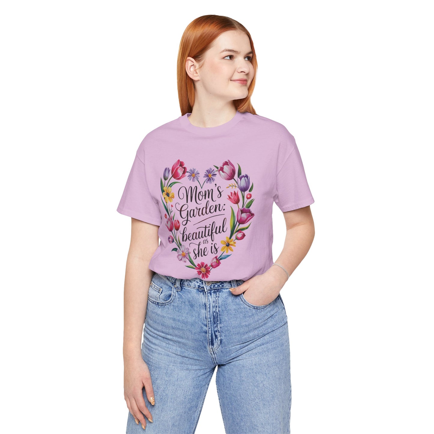 Mom's Garden is as Beautiful as She Is Mother's Day Comfort Colors Unisex T-Shirt, showcasing a heart-shaped floral design, worn by a person with red hair and blue jeans, embodying stylish comfort.