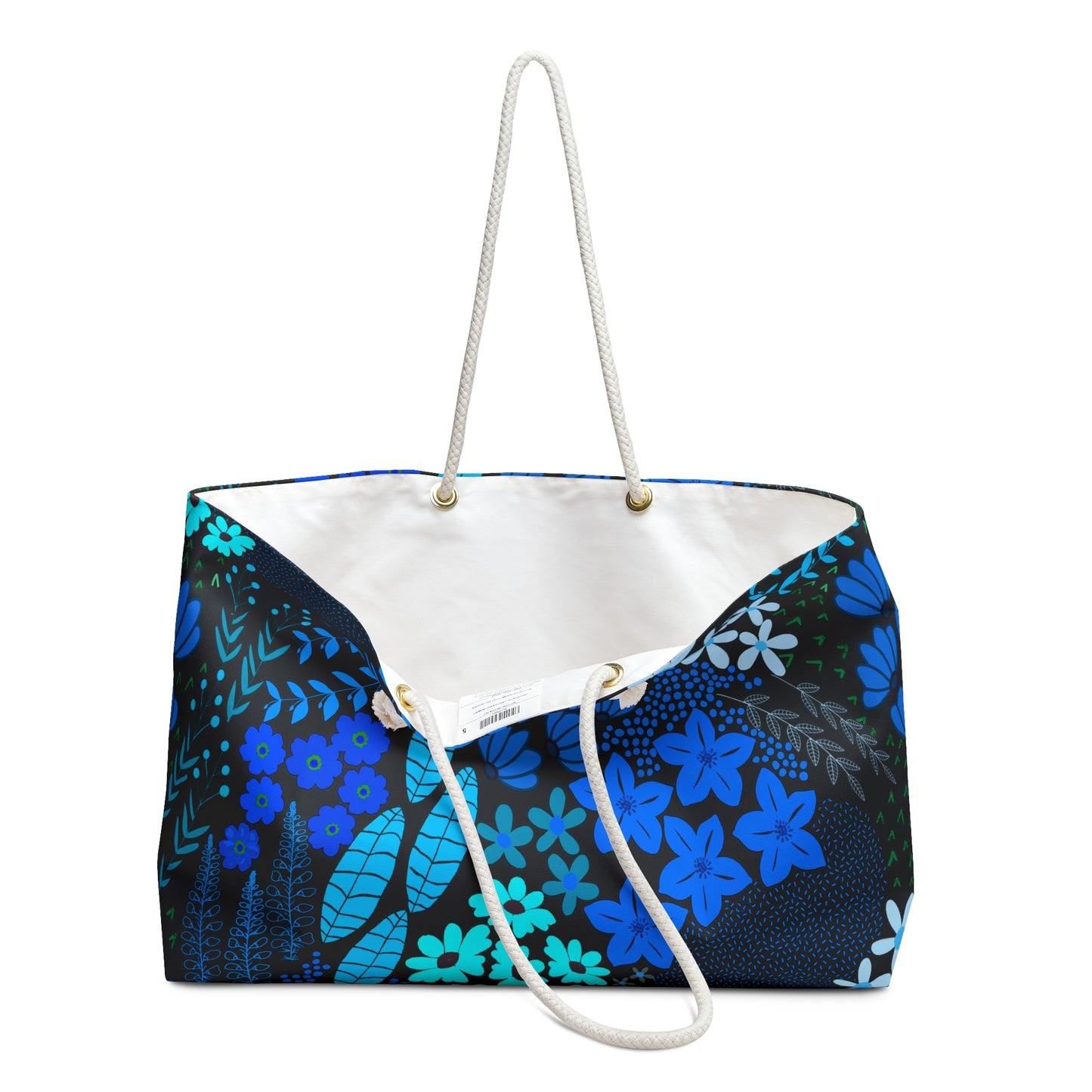 Floral Weekender Bag with bold blue and teal patterns, braided rope handles, and brass grommets, offering a modern-botanical style. Ideal for travel, reflecting FireBrook Designs' uplifting, practical essence.