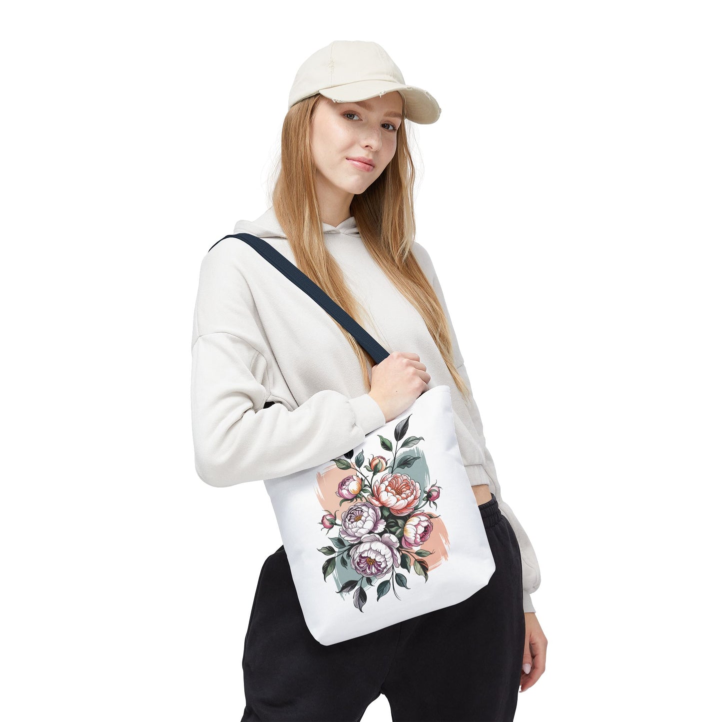 Vintage Peony Tote Bag held by a woman in a white hoodie, showcasing a detailed floral design, ideal for carrying essentials. A stylish, durable accessory from FireBrook Designs, perfect for nature enthusiasts.