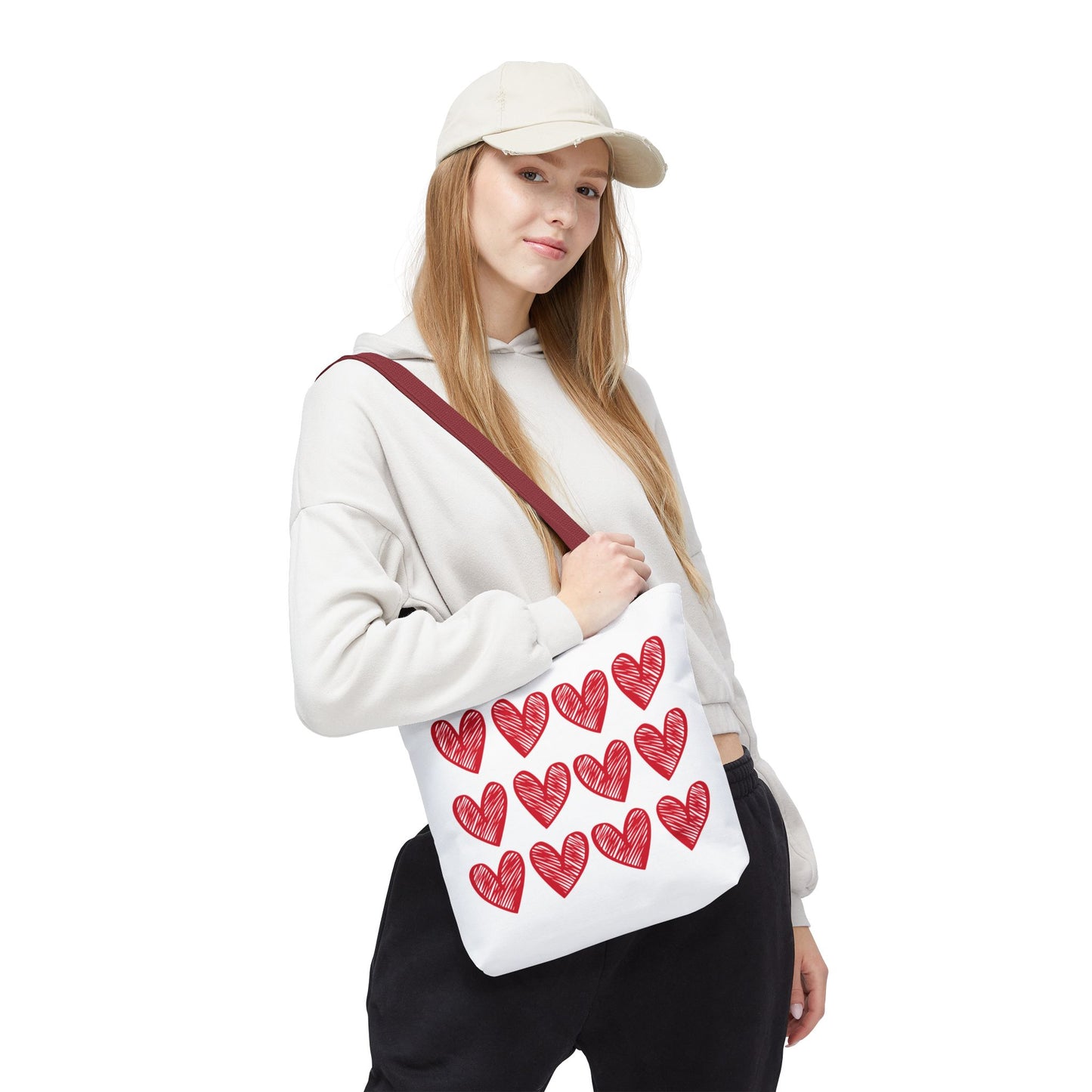 Hearts Tote Bag being held, showcasing its quirky heart pattern. Ideal for adding love-themed charm to daily outfits, aligning with FireBrook Designs' focus on stylish and joyful essentials.