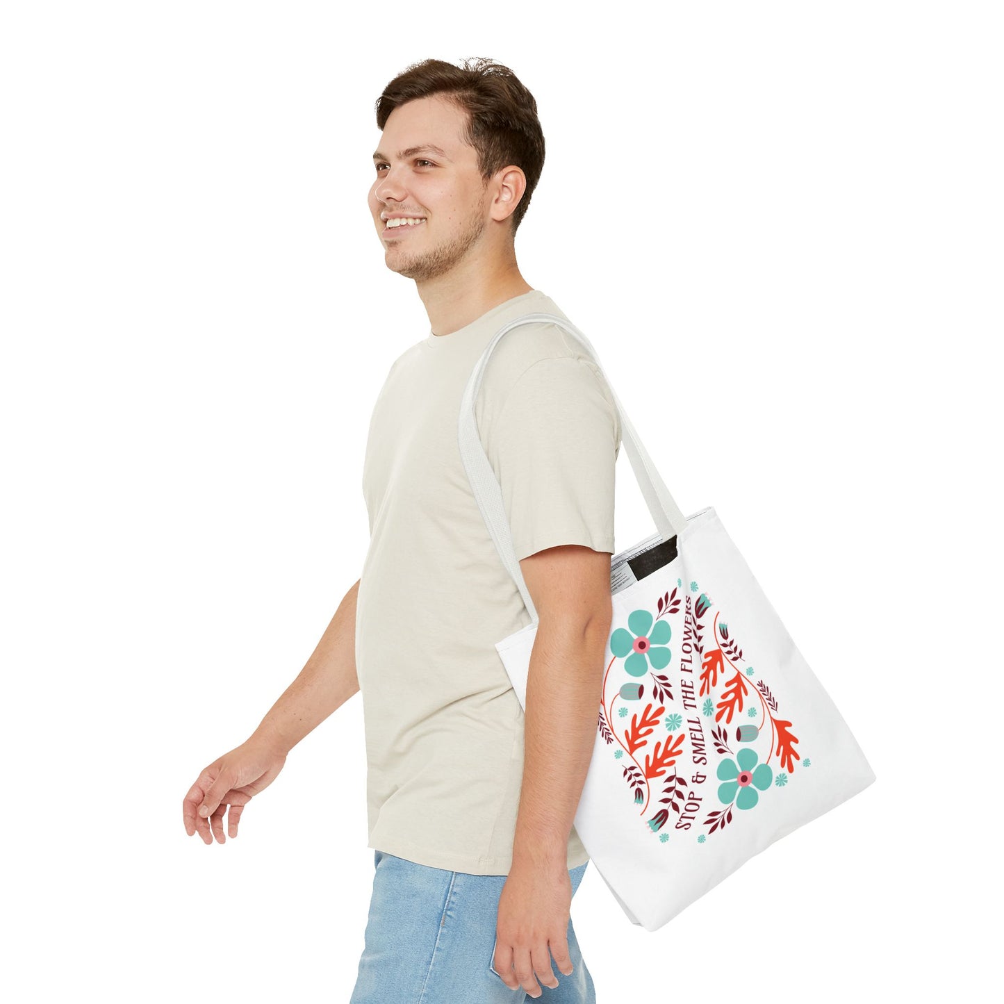 Man carrying the Stop and Smell The Flowers Tote Bag, showcasing its nature-inspired design, perfect for daily use and spreading positive vibes.