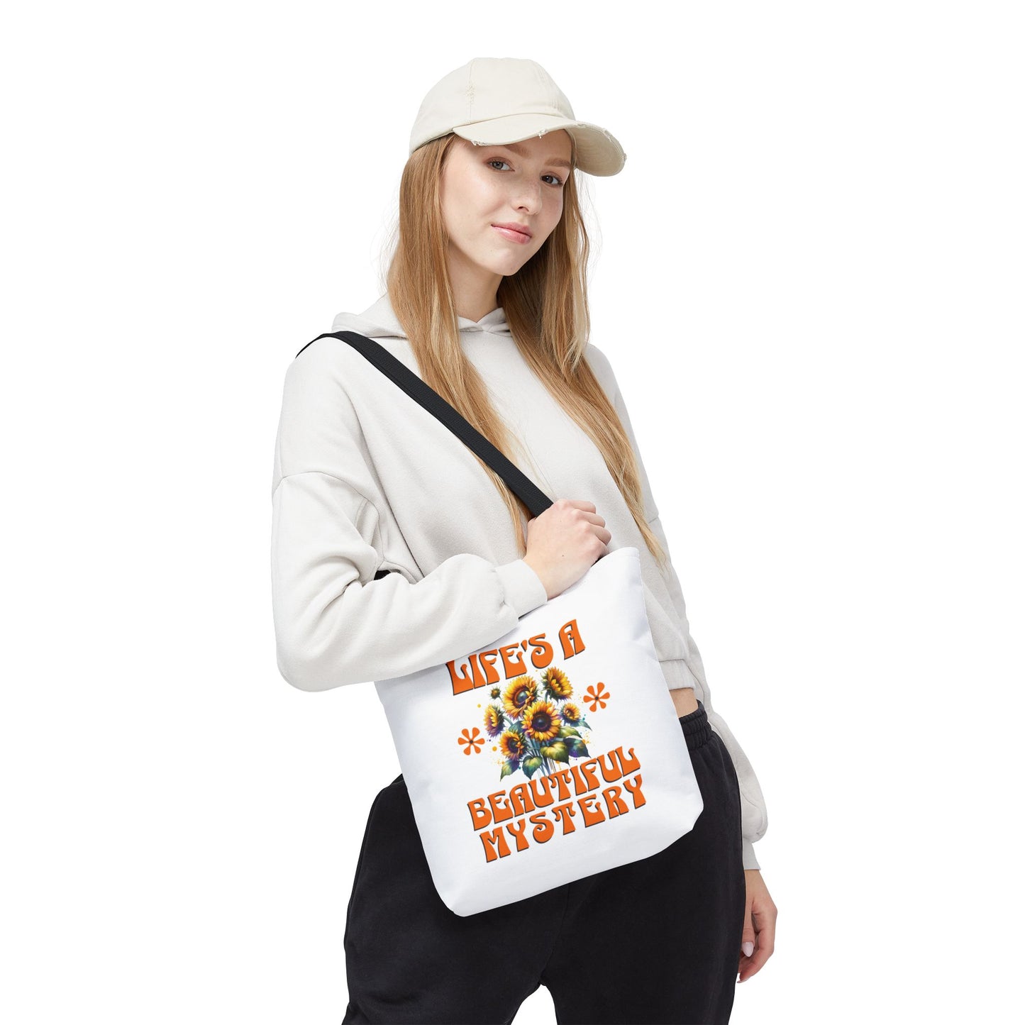 Woman holding Life's A Beautiful Mystery Tote Bag with flower design, showcasing its durable build and stylish appeal, ideal for daily adventures and gifting.