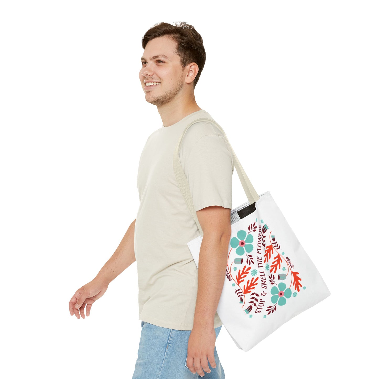 Man carrying the Stop and Smell The Flowers Tote Bag, featuring a floral design, perfect for everyday essentials and embodying tranquility and positive vibes.