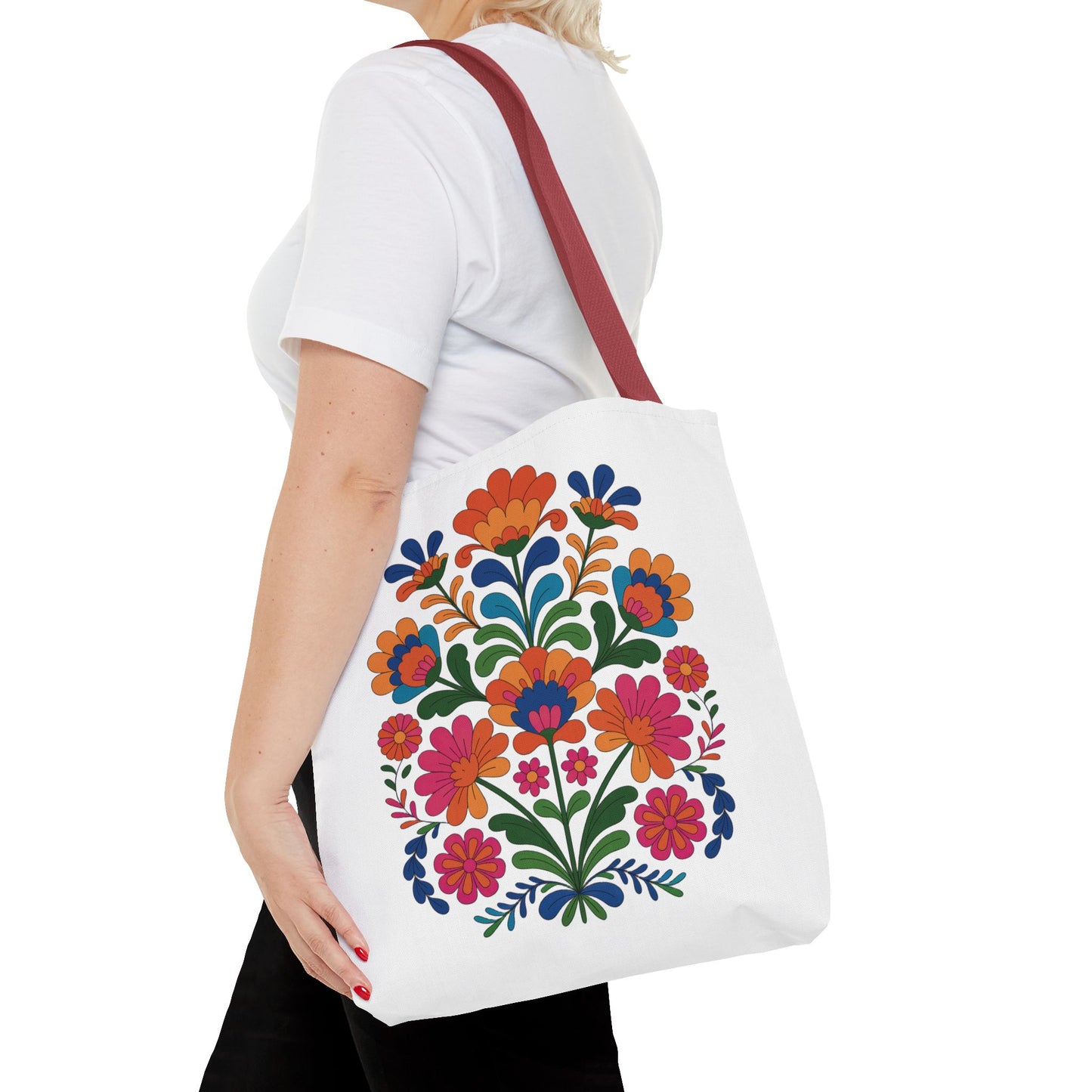 Red Folk-Art Floral Tote Bag features a vibrant, organic floral design in red tones, ideal for carrying essentials. The bag's seamless look and durable construction make it perfect for everyday adventures.