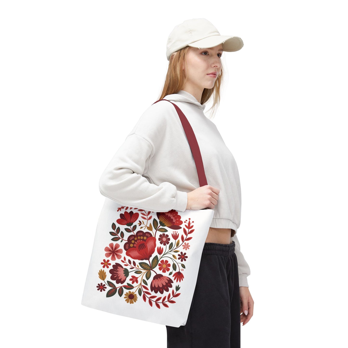 Red Floral Folk-Art Style Tote Bag features a vibrant organic floral illustration with bold red, blush, and blue flowers. Enhanced by green leaves and navy or orange accents, perfect for everyday use.