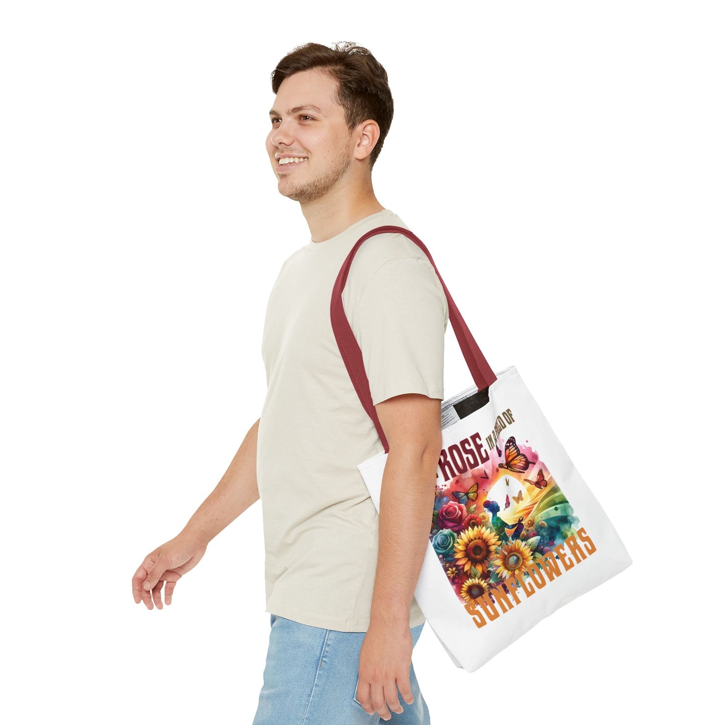 Be the Rose in a Field of Sunflowers Tote Bag, featuring a nature-inspired design with flowers and butterflies, carried by a smiling man.
