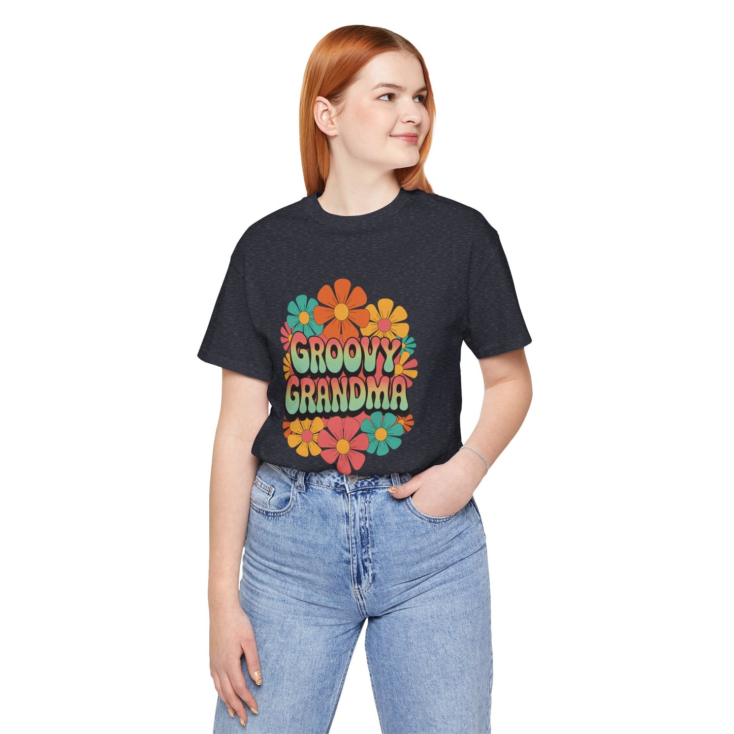Groovy Grandma for Mother's Day Bella+Canvas Unisex T-Shirt features a vibrant floral graphic, worn by a woman in blue jeans, embodying retro charm and playful style.