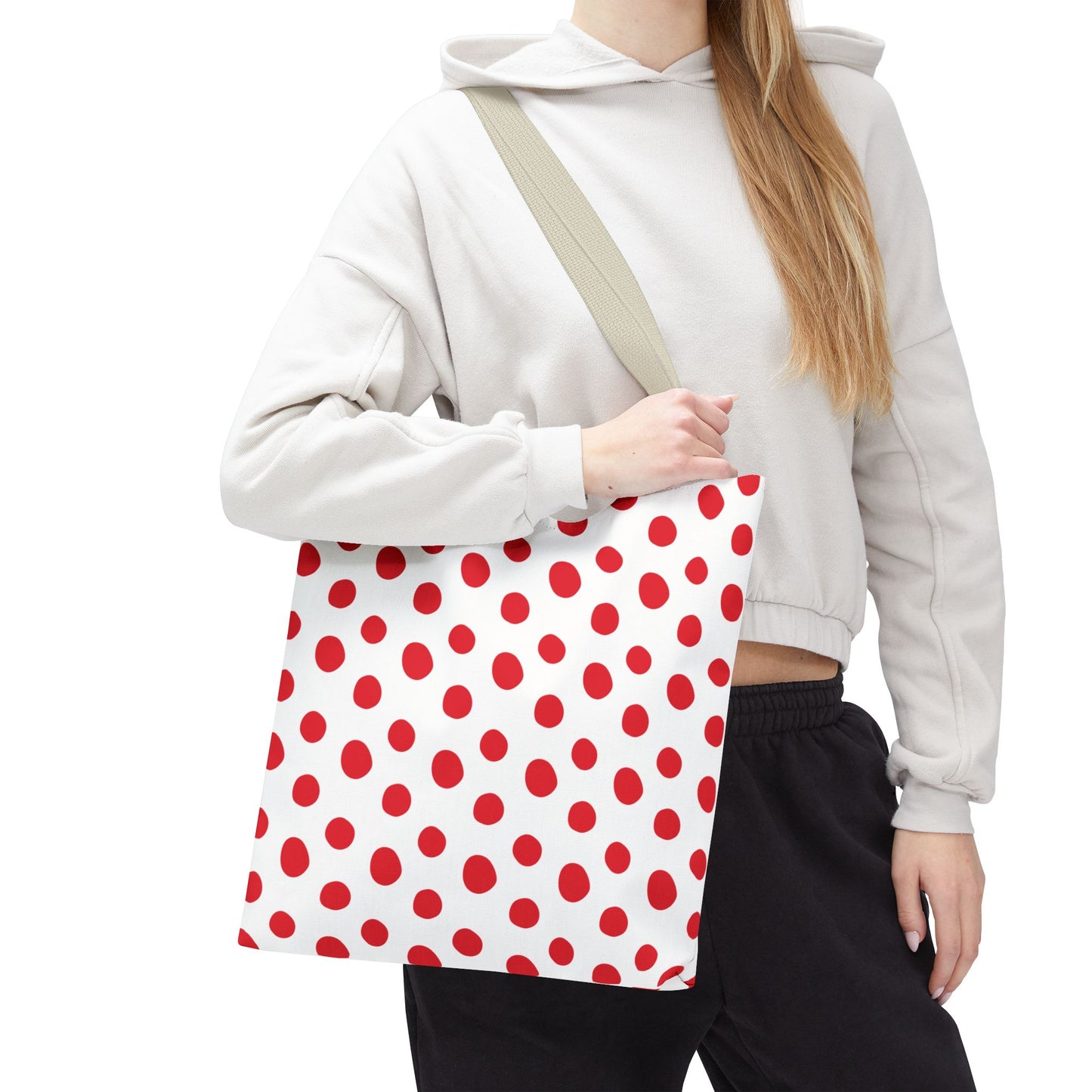 Red Polka Dots Tote Bag held by a woman, showcasing its playful design with red polka dots. Ideal for daily errands or beach trips, reflecting FireBrook Essentials' emphasis on stylish, joyful utility.