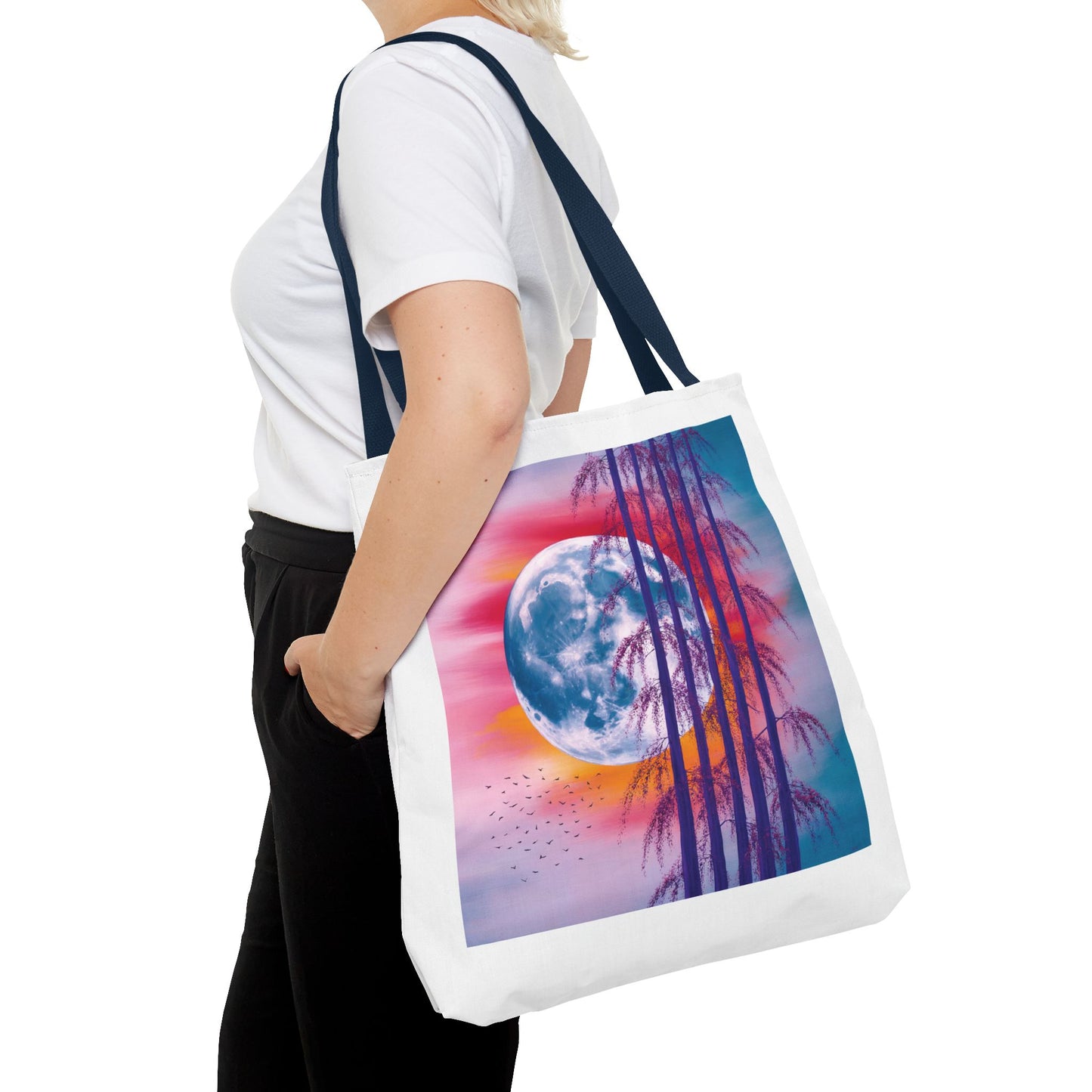 Moonlit Landscape Tote Bag featuring an abstract full moon scene with silhouetted trees against a vibrant sunset sky, ideal for nature enthusiasts. Durable polyester with reinforced handles, available in multiple sizes.
