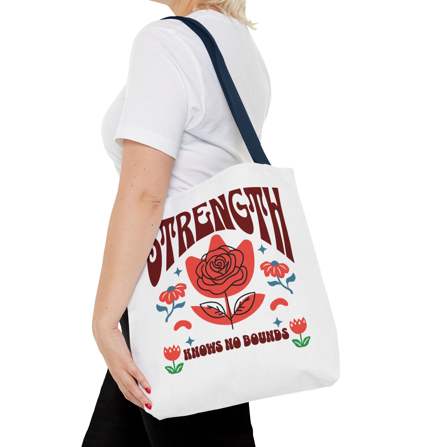 Strength Knows No Bounds Tote Bag held by a person, highlighting its durable, stylish design with motivational text, ideal for everyday use.