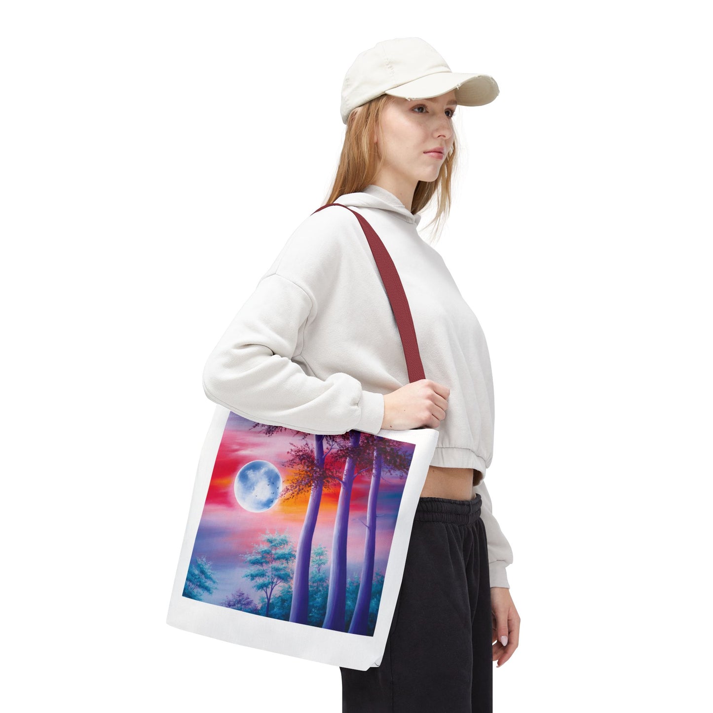 Moonlit Forest Tote Bag featuring an abstract full moon scene with towering trees against a sunset sky, embodying a mystical vibe. Durable polyester with reinforced handles, ideal for art lovers and everyday use.