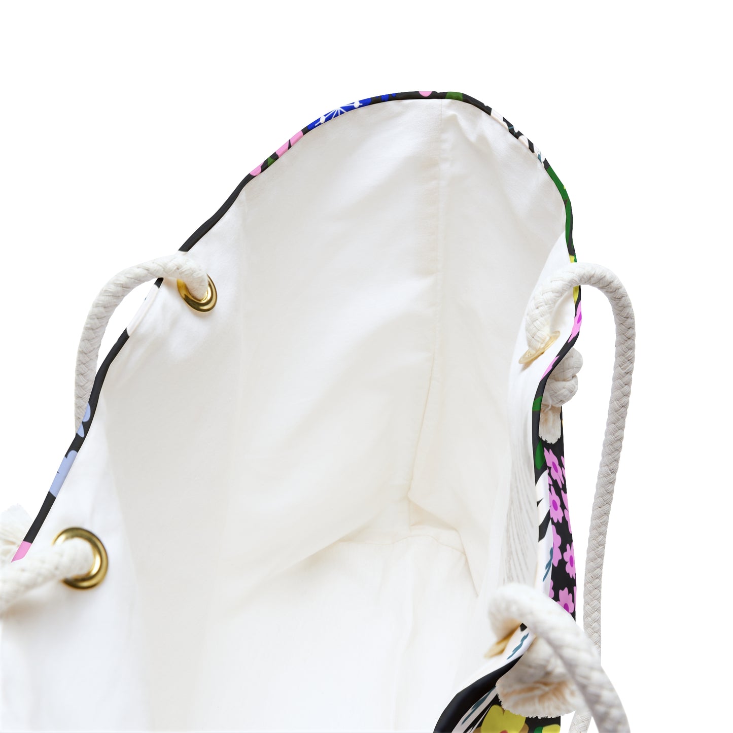 Weekender Bag with a spacious white-lined interior, featuring a vibrant floral trim and sturdy braided rope handles, designed for stylish travel and ample storage. Ideal for joyful getaways.