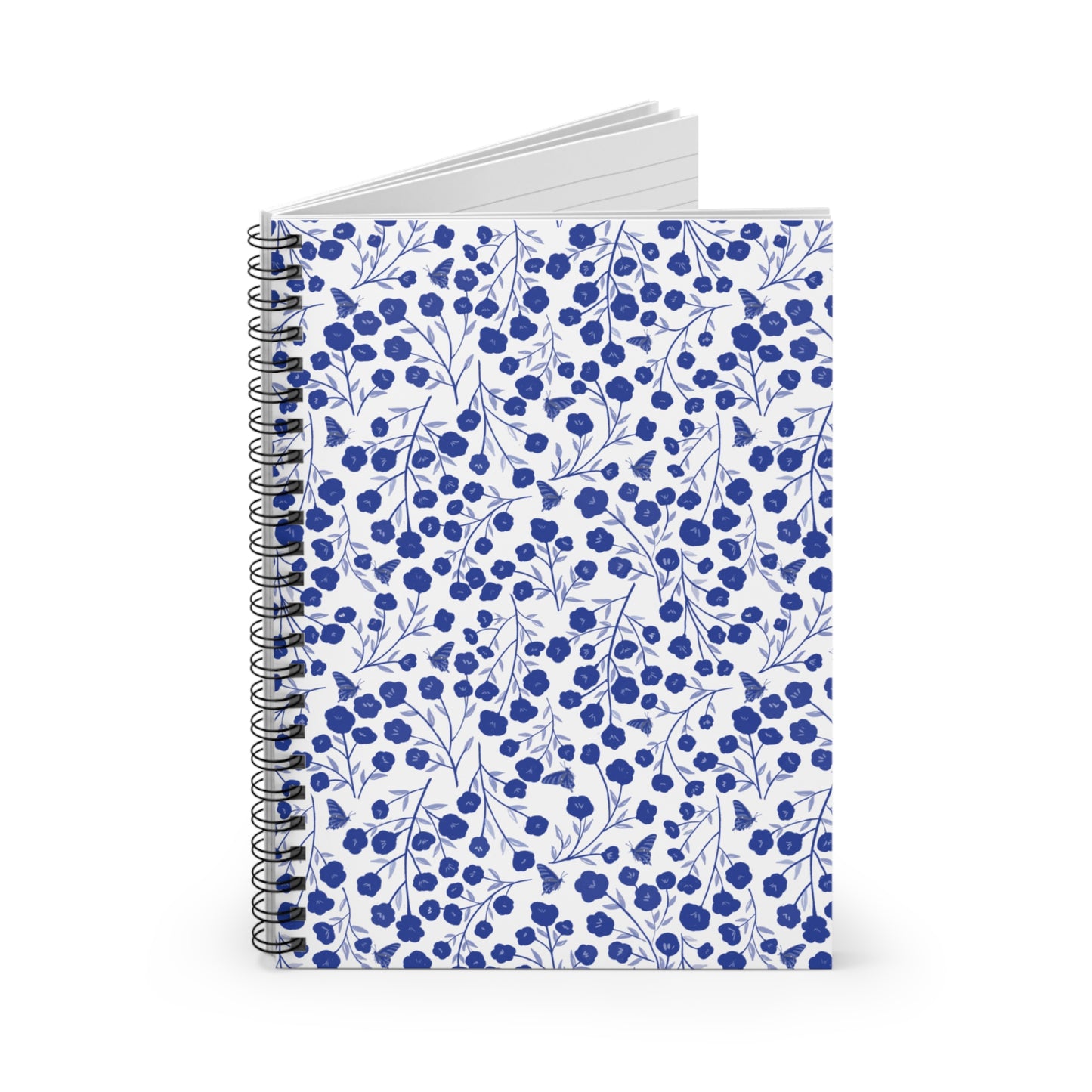 Floral Spiral Notebook: Featuring a white cover with blue floral and butterfly patterns, this compact journal offers lined pages and a durable metal spiral, perfect for capturing creative thoughts and plans.