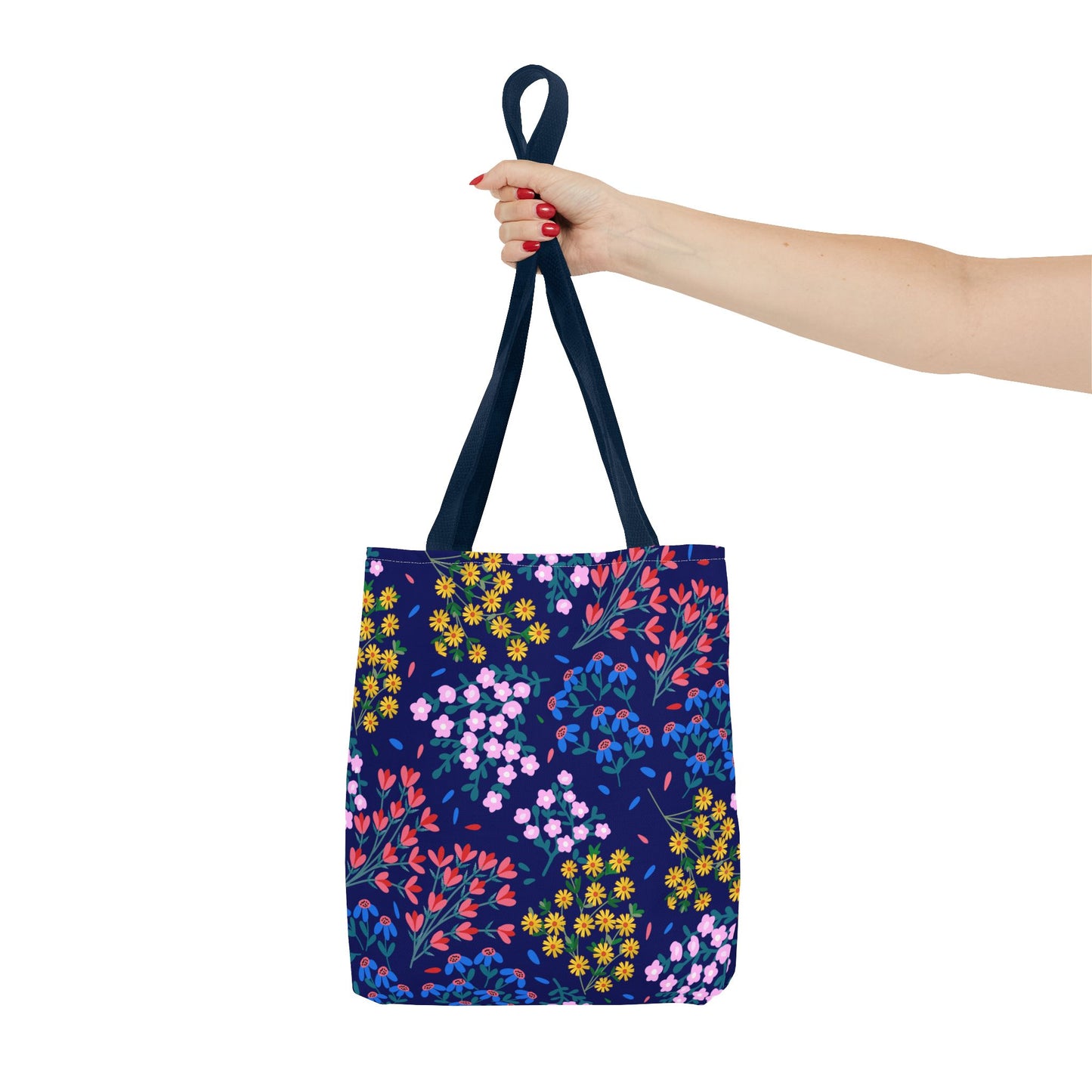 Floral Night Garden Tote held by red-nailed hand, showcasing its vibrant hand-drawn floral pattern on navy, embodying FireBrook Designs' blend of style, durability, and joyful sophistication.
