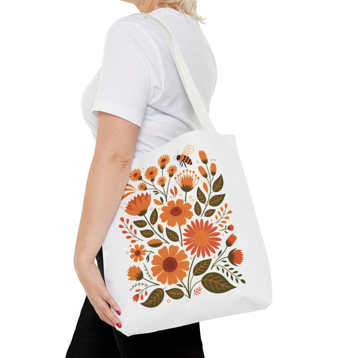 Folk Floral Tote Bag showcasing hand-drawn wildflowers in warm hues, ideal for nature enthusiasts. Features durable polyester, reinforced handles, and boxed corners. Available in three sizes for versatile use.