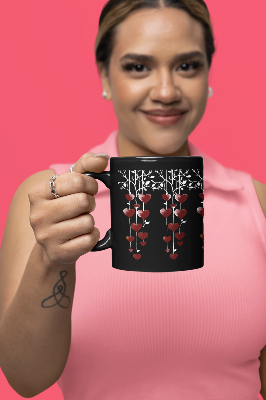 String of Hearts Mug (11oz, 15oz) held by a smiling woman, showcasing its romantic heart design, perfect for Valentine's Day or anniversaries, reflecting FireBrook Designs' joyful and uplifting style.