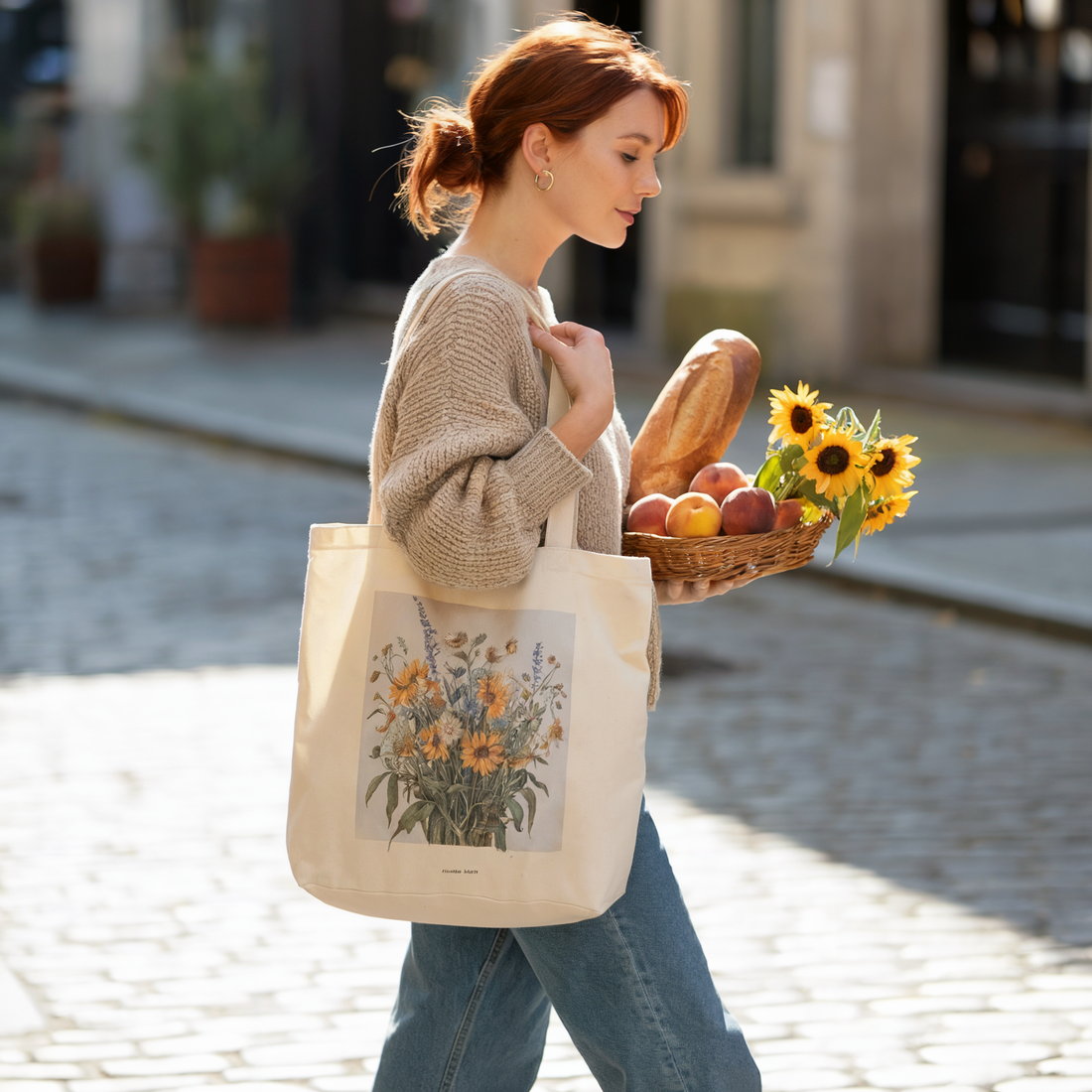 A woman outdoors carries a basket of fruit and a stylish handbag, embodying FireBrook Essentials' blend of comfort and positivity through fashion accessories.