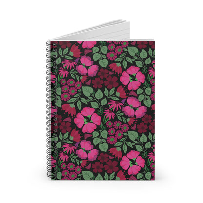 Floral Spiral Notebook stands upright, featuring pink and magenta blossoms on a dark cover. Its blank, lined pages fan out, ideal for organizing thoughts and inspiring creativity for any occasion.